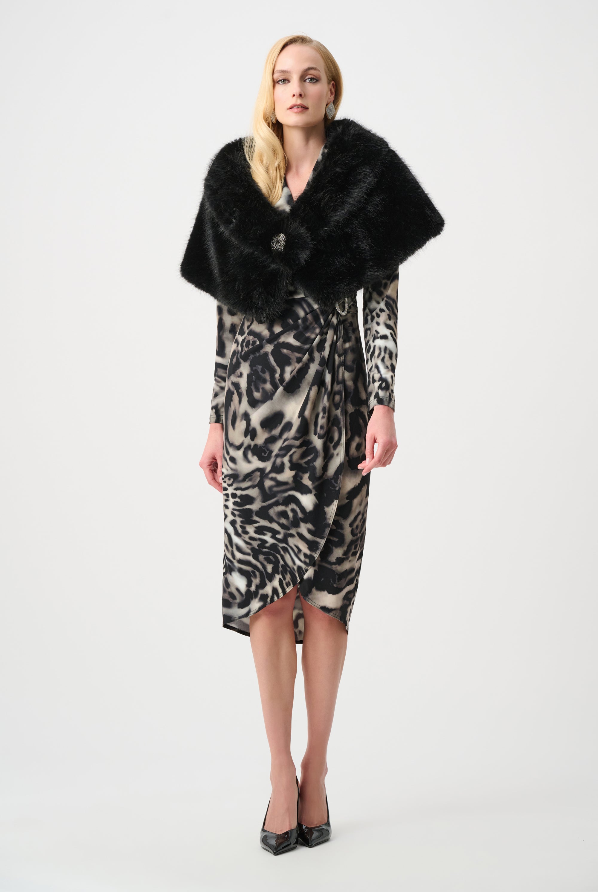 Woman wearing a leopard print dress with a black fur shawl on a white background