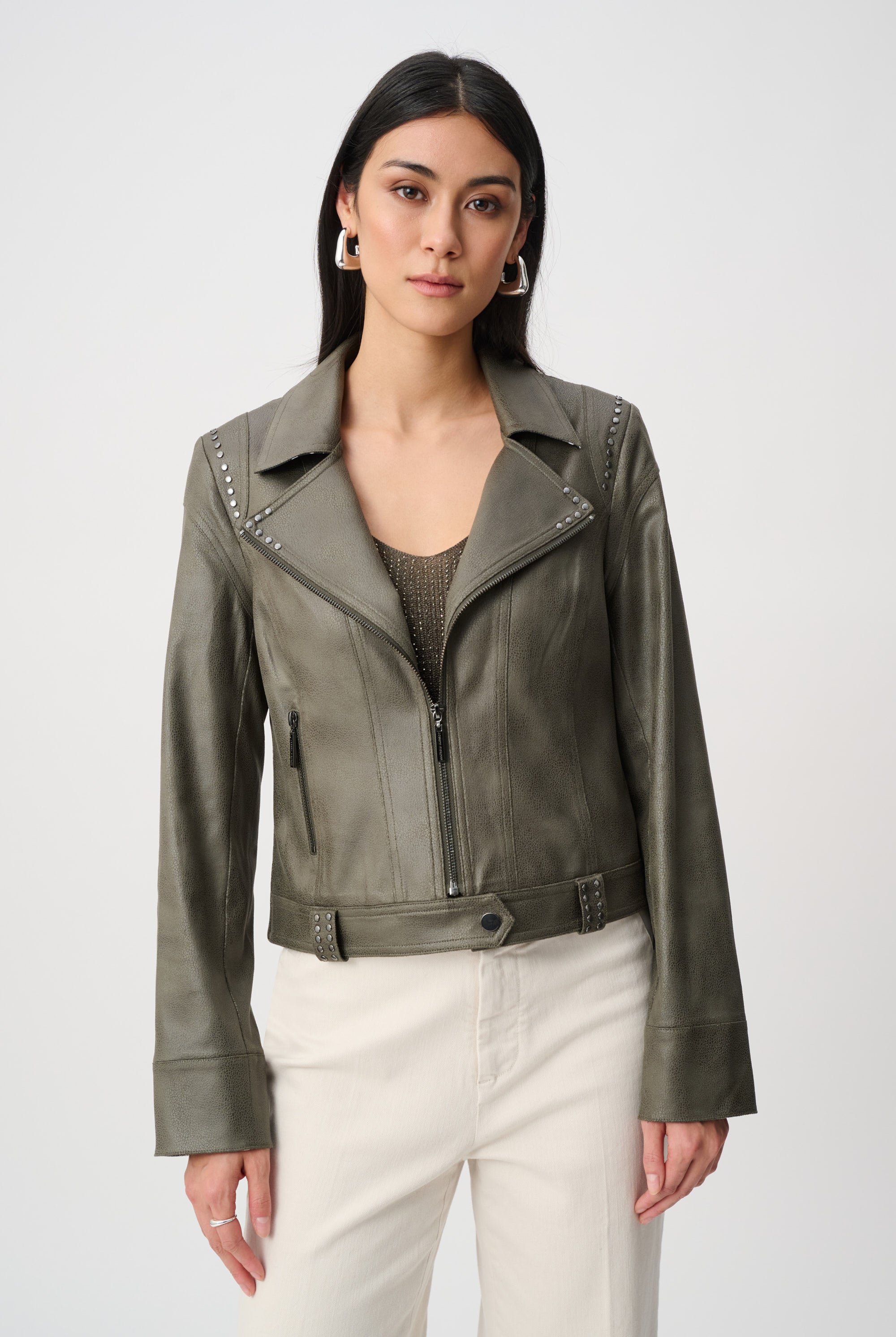 Woman wearing a green leather jacket on a white background