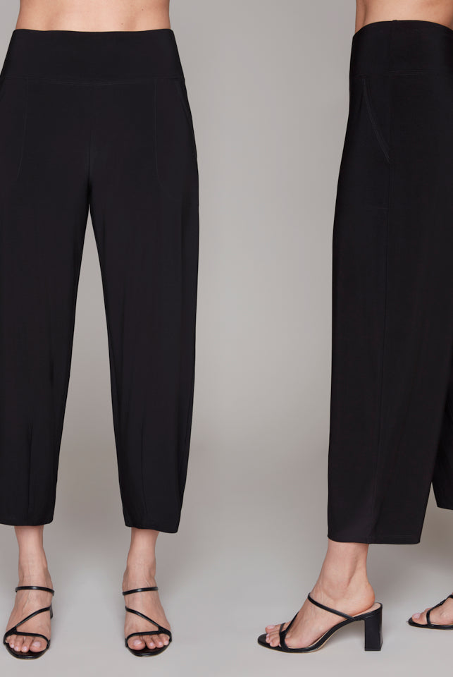 Black pants worn by a person on a plain background