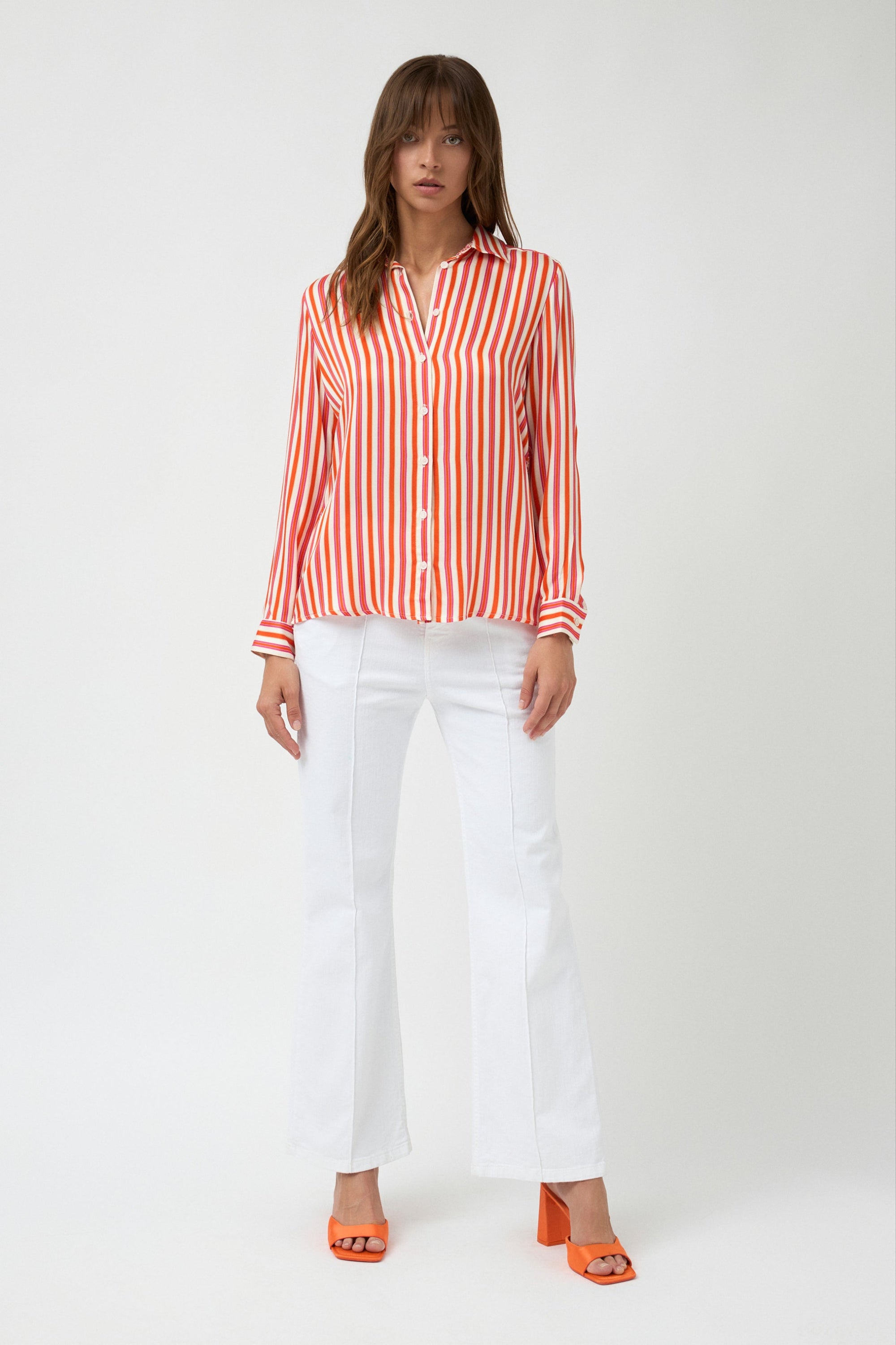 orange pink white stripe button through shirt and white pants worn by model