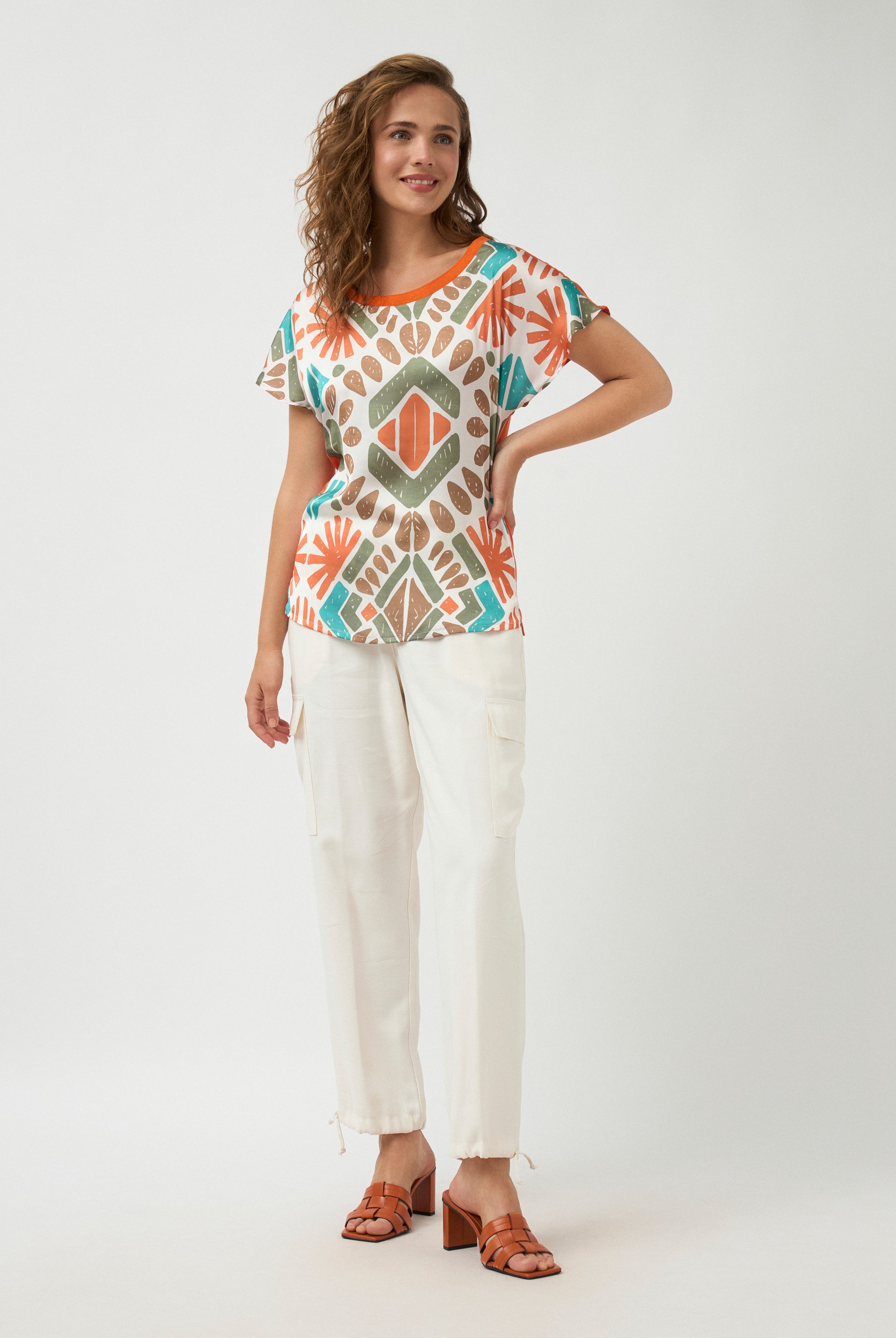 geometric print short sleeve tee and white pants worn by model