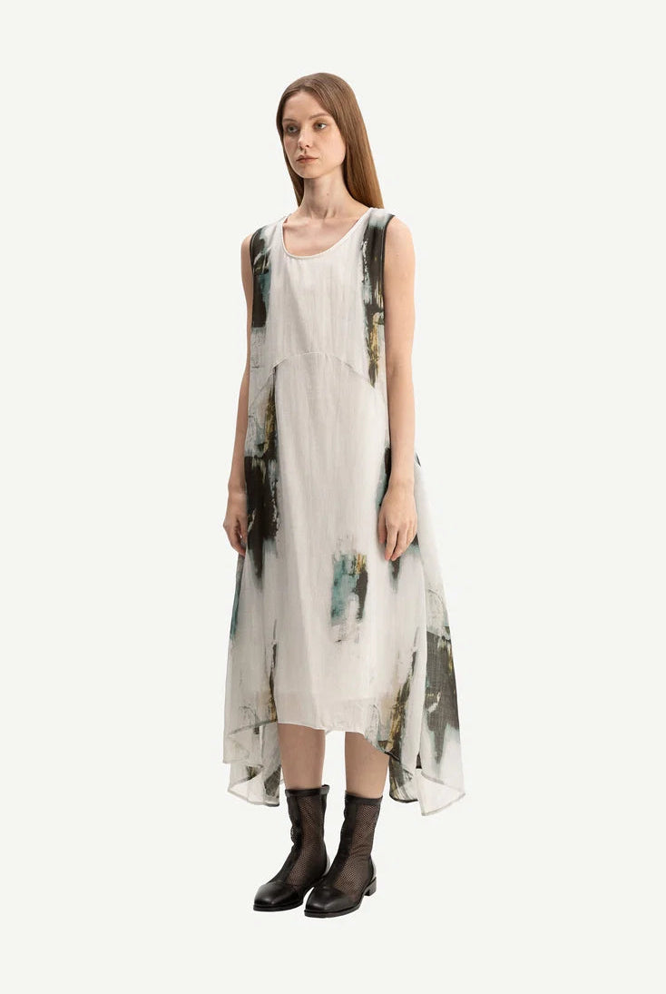 Woman wearing a sleeveless dress with abstract design on a white background
