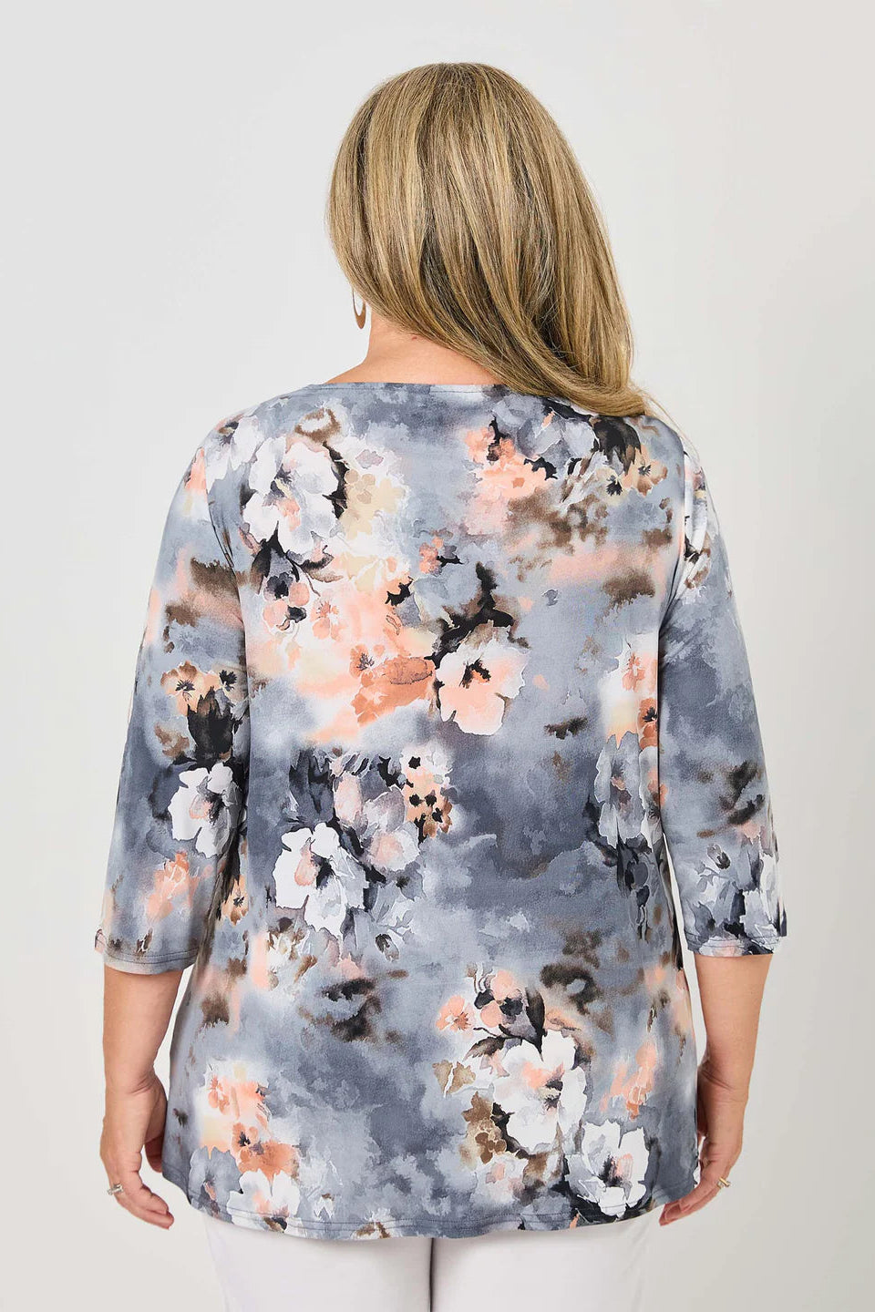 Woman wearing a floral blouse with a gray background