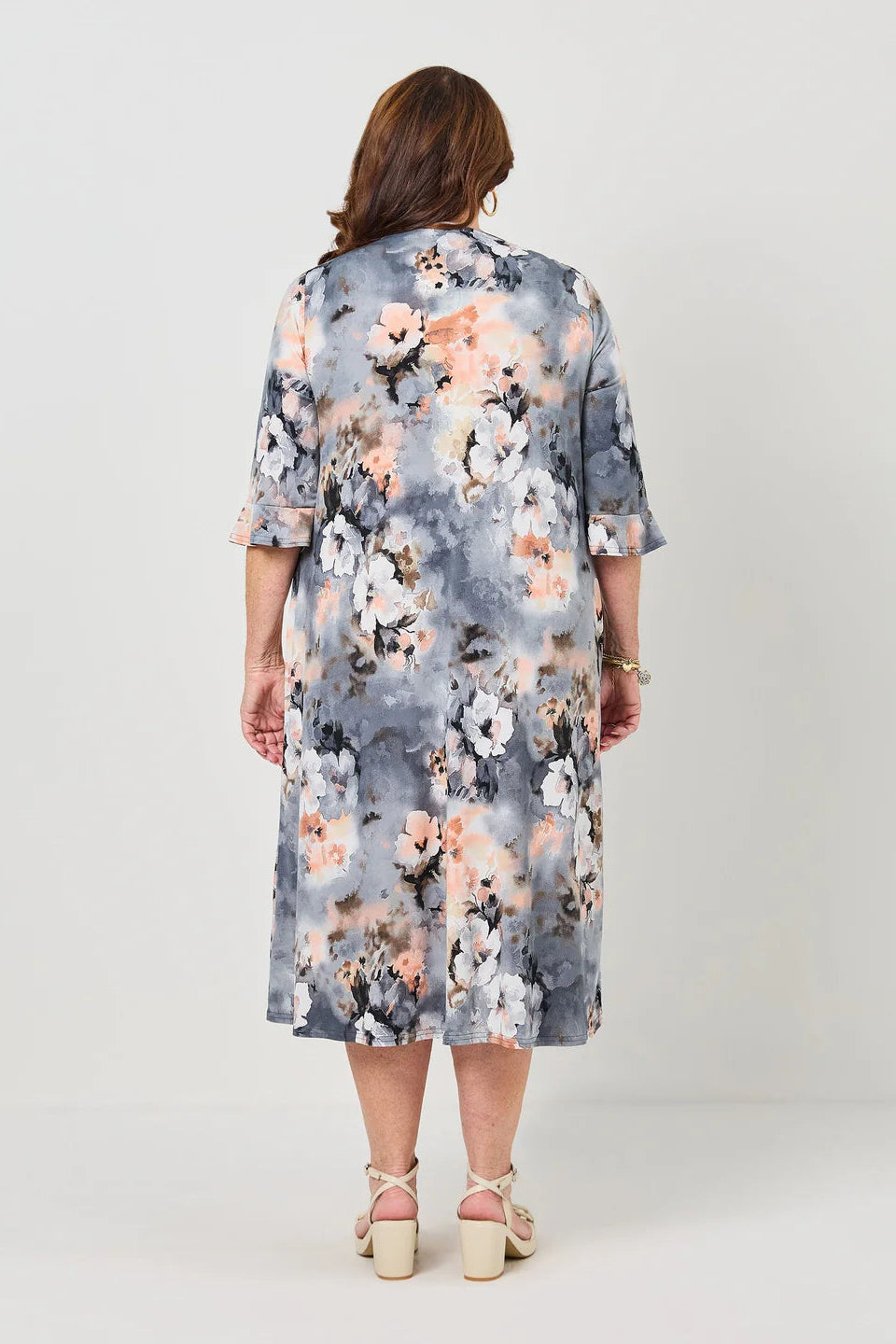 Woman wearing a floral dress with a gray background