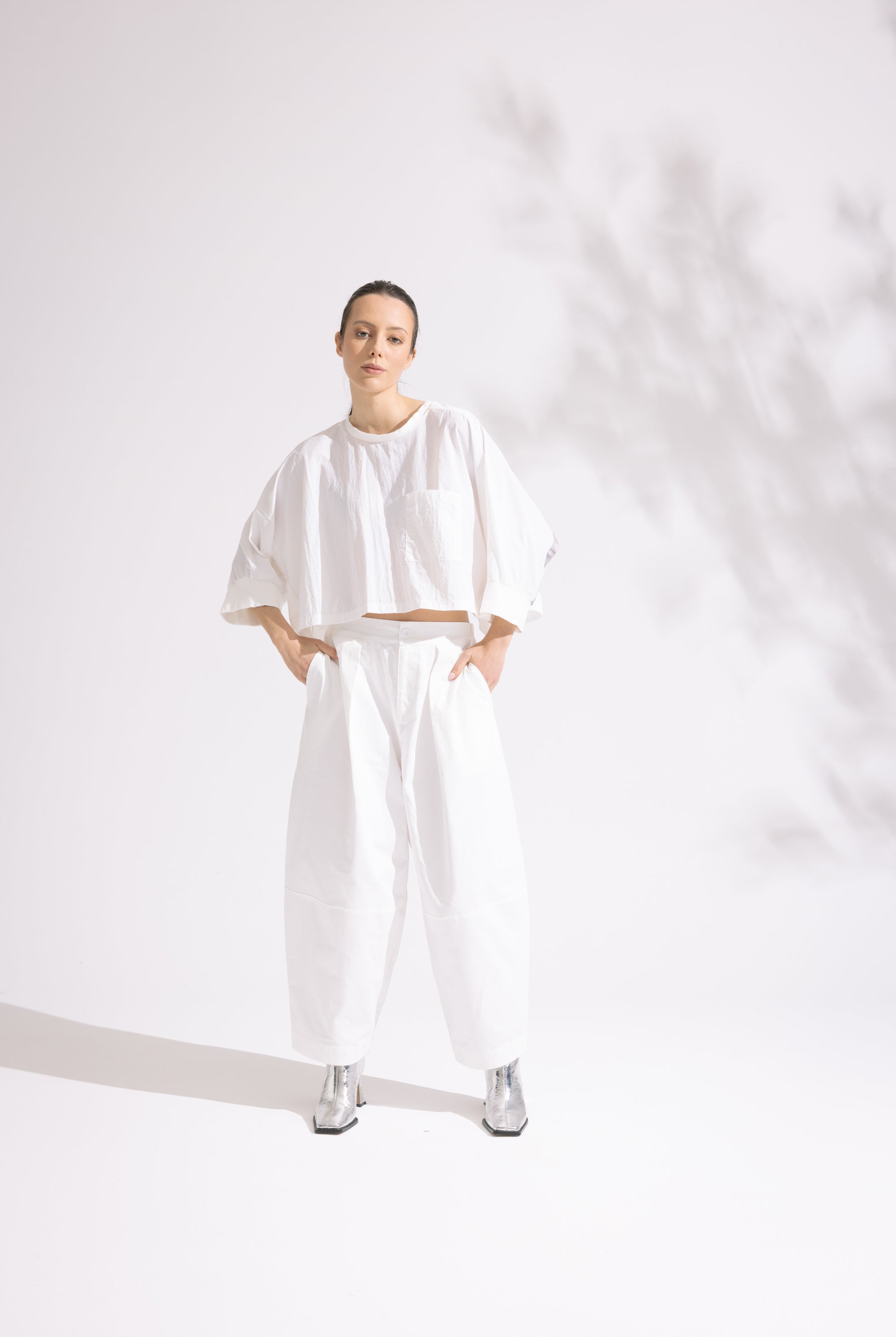Person wearing a white outfit on a plain background