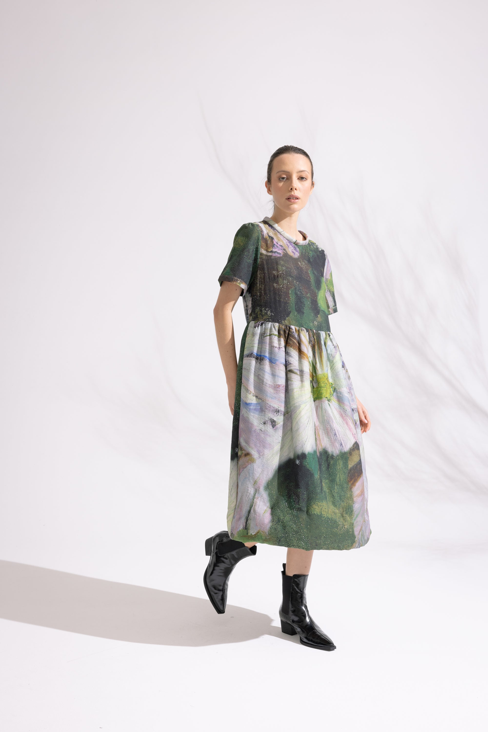 Woman wearing a patterned dress on a white background