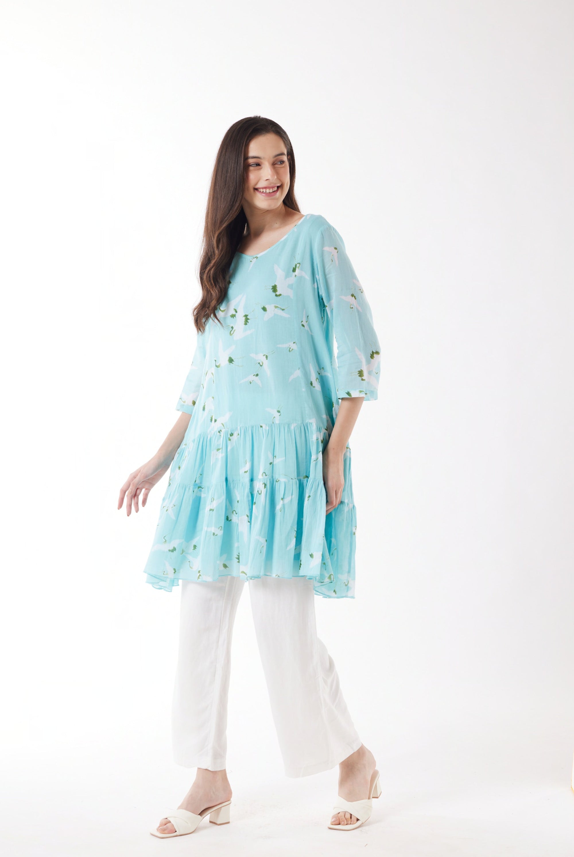 blue with white bird print midi dress with white pants worn by model