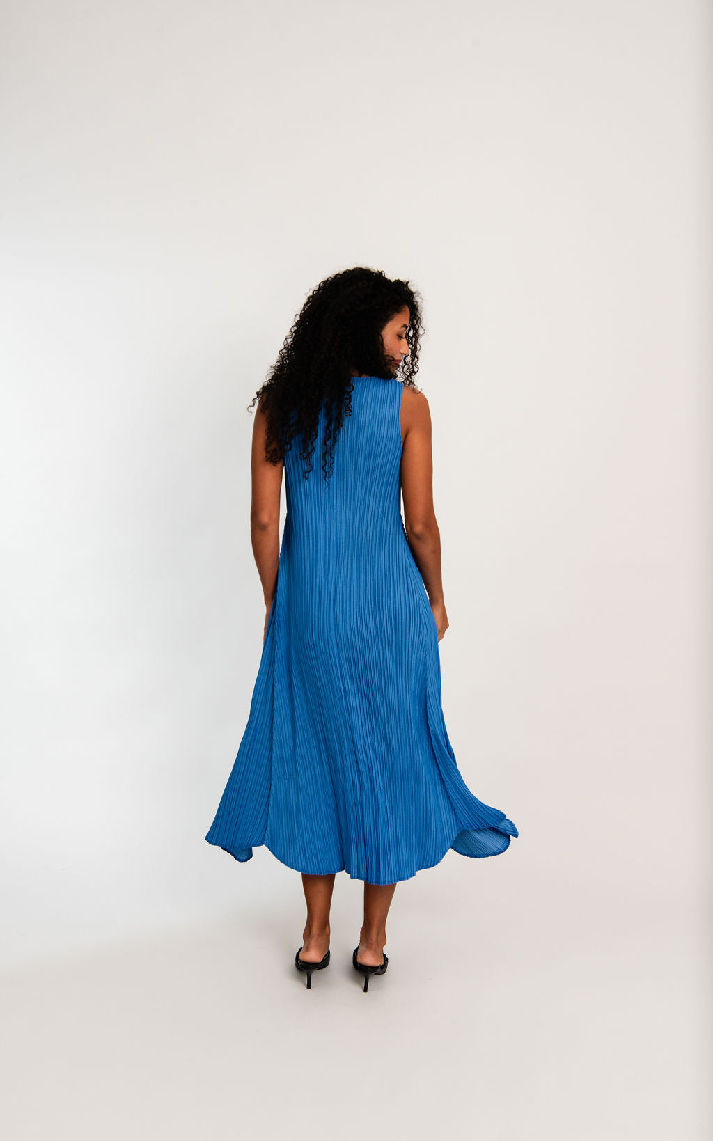 midi maxi pleated dress in royal blue worn by model back view
