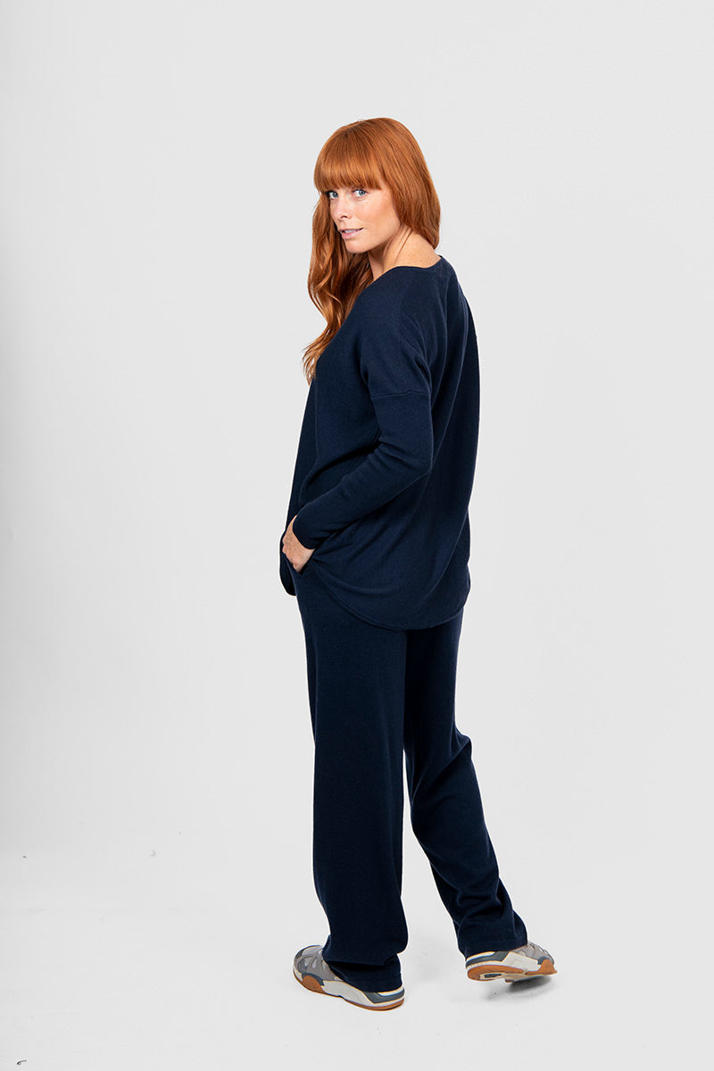 Woman wearing a navy blue outfit on a white background