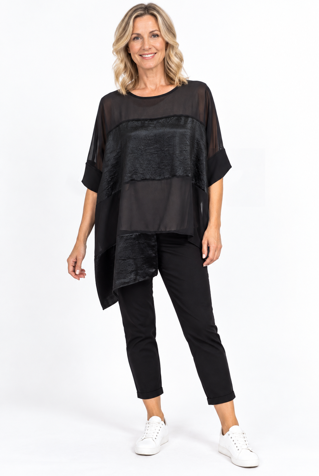 women wearing a black panelled top on a plain background