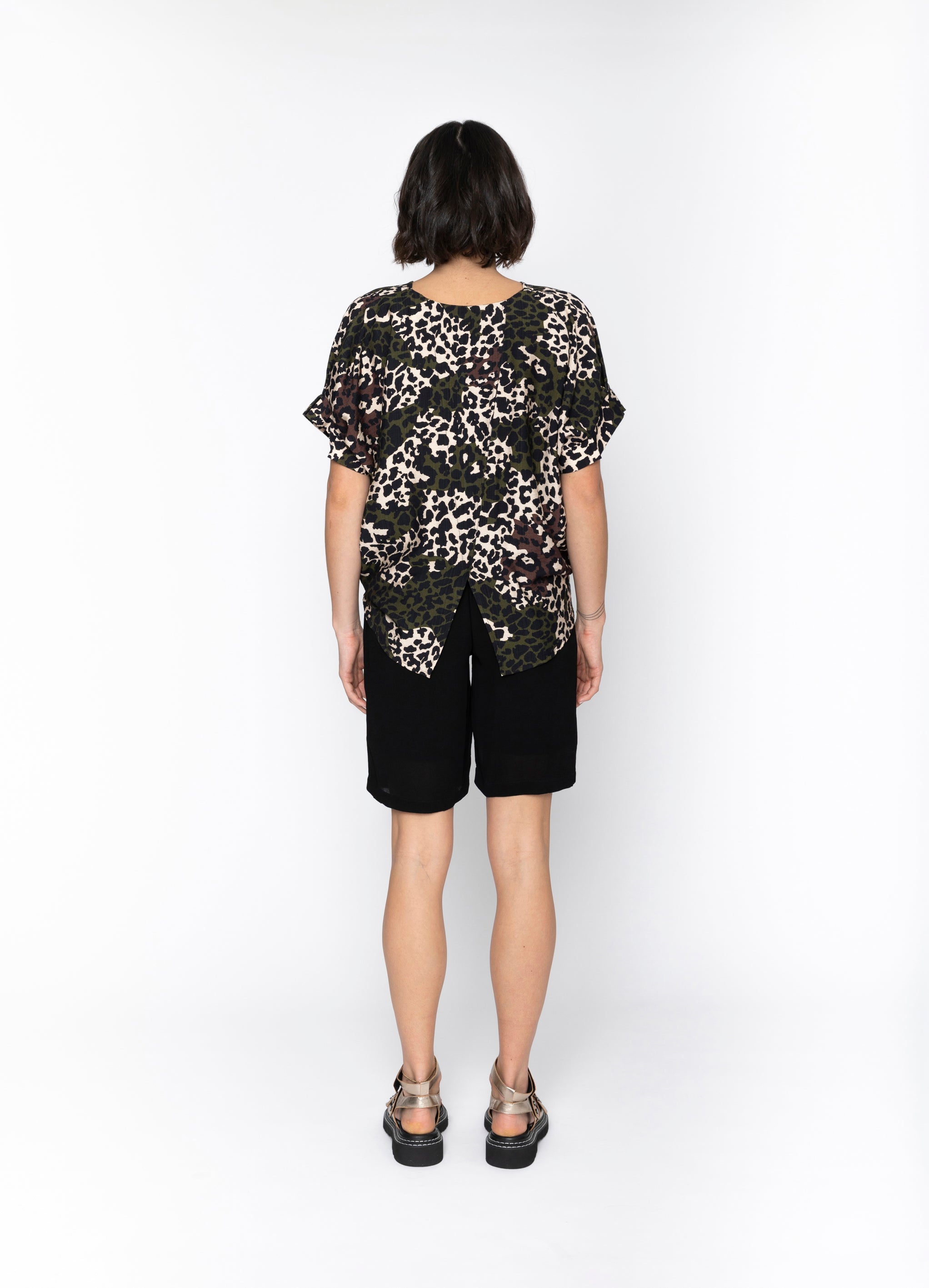 dark multi colour leopard print top and black shorts worn by model back