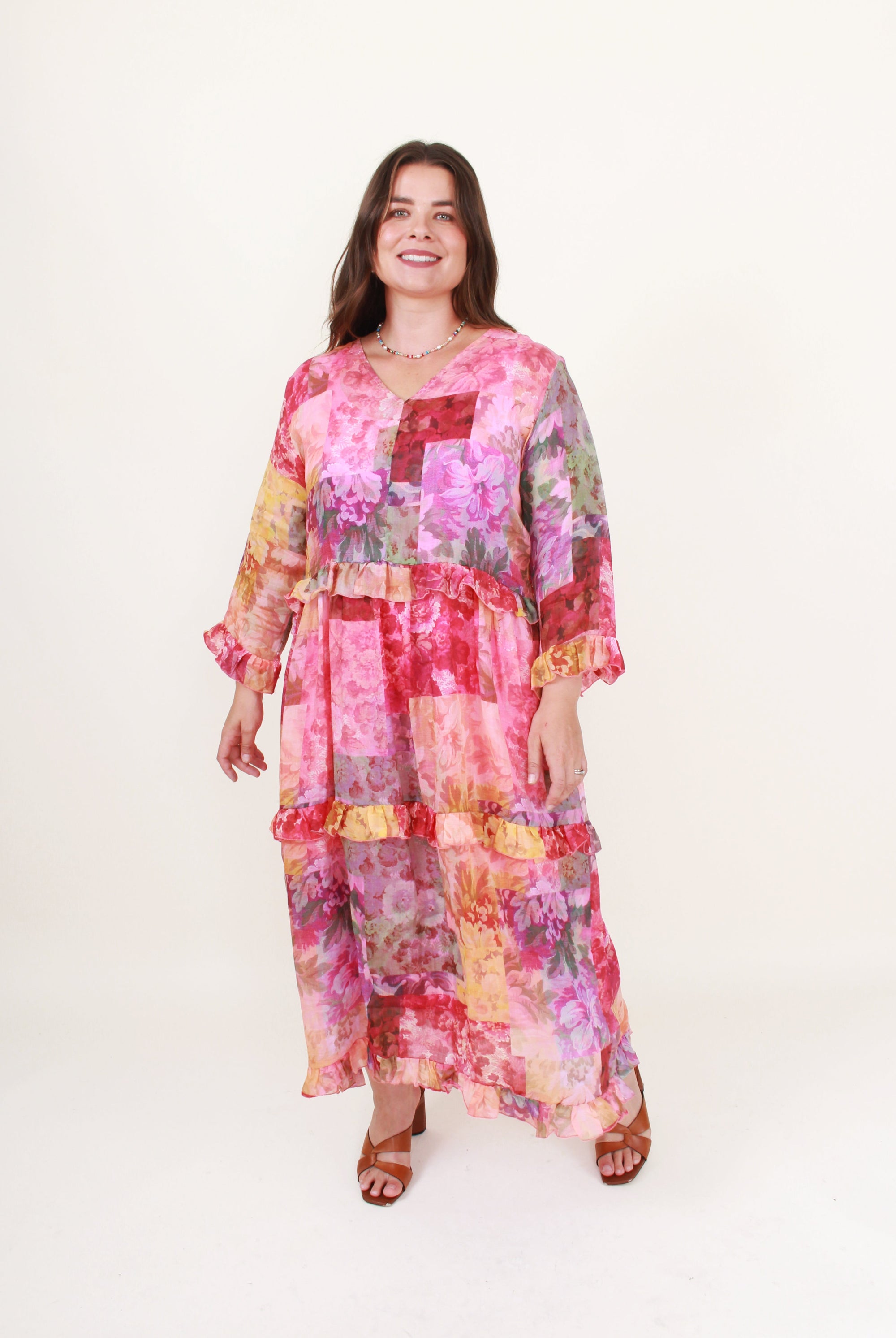 Woman wearing a colorful patchwork dress on a white background