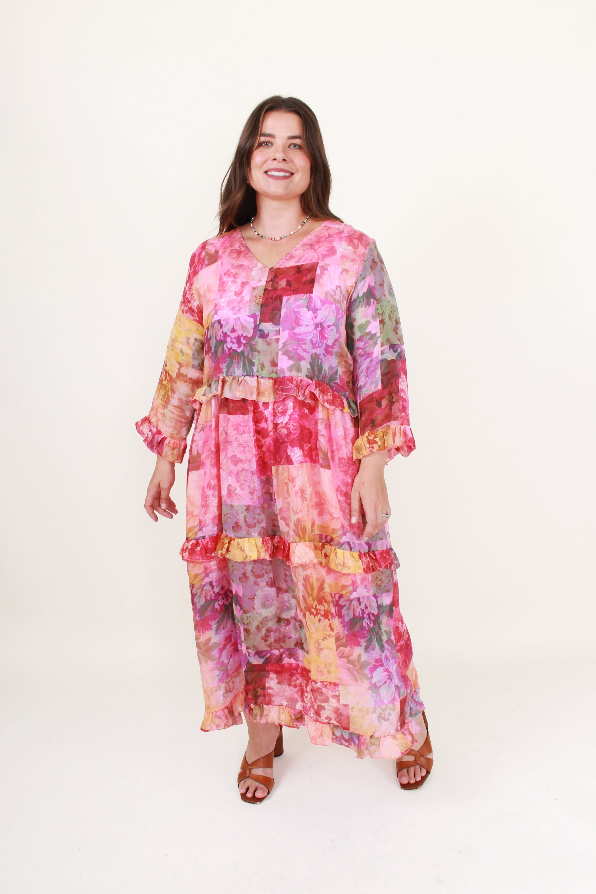 Woman wearing a colorful patchwork dress on a white background