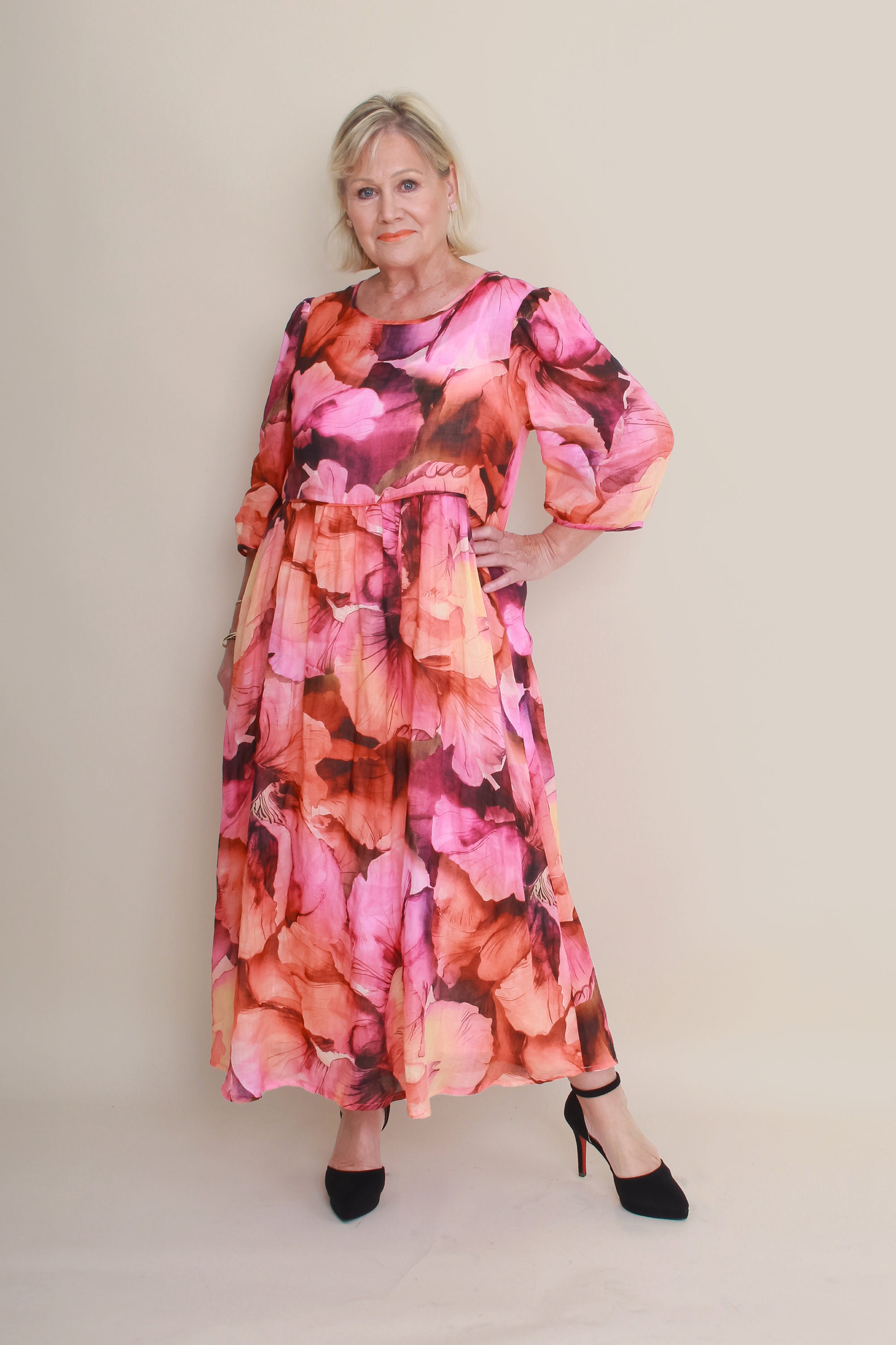 Woman wearing a floral dress with a plain background