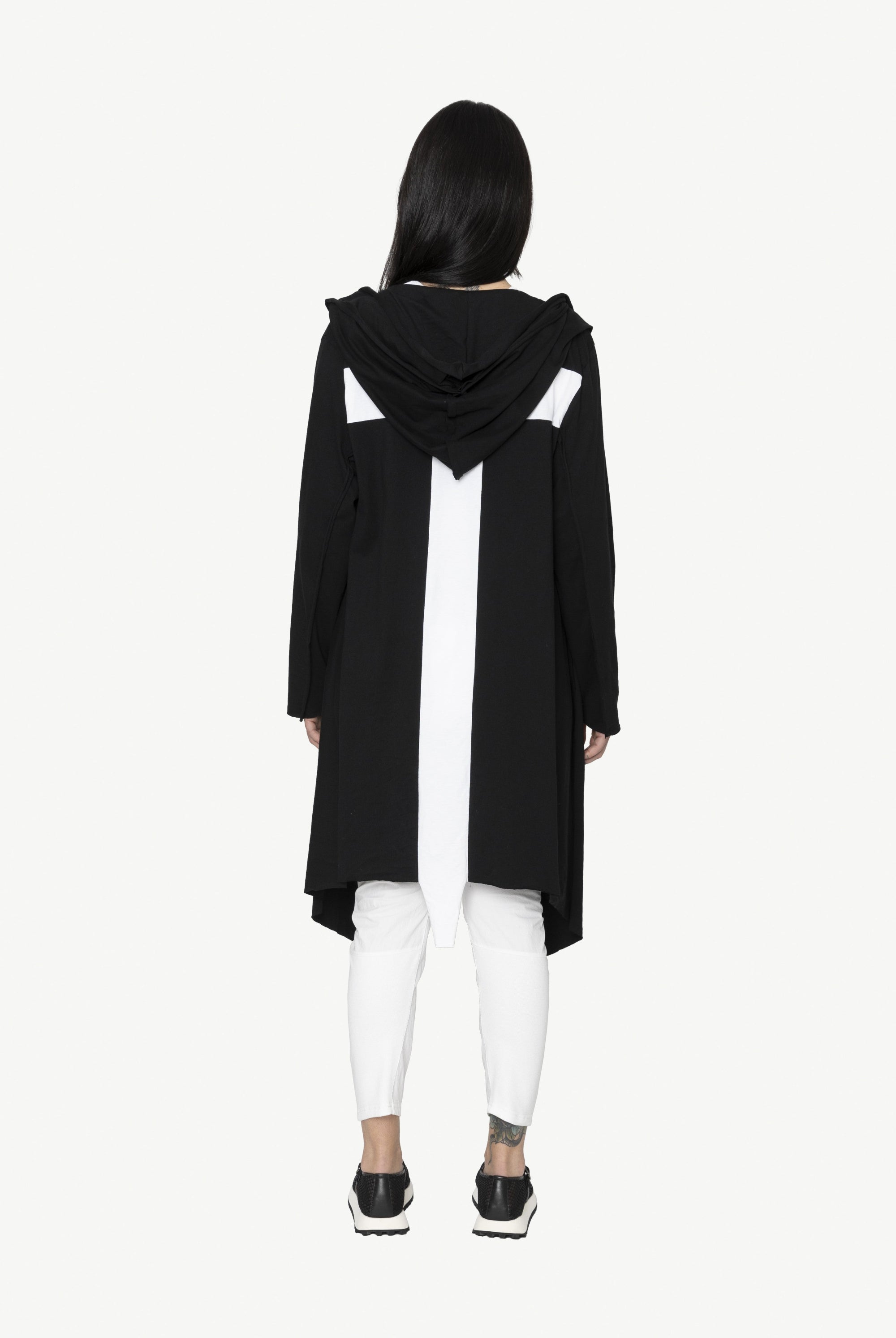 black longline jacket over white outfit worn by model cross back