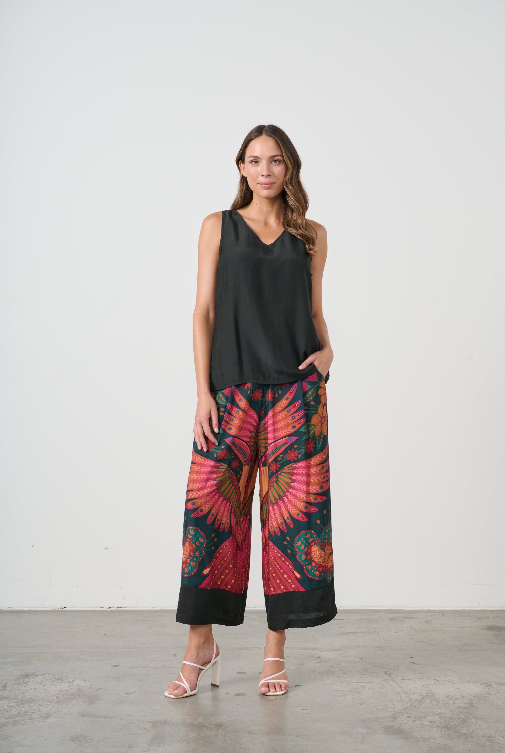 womens wide leg pant with multi toucan print and black top worn by model