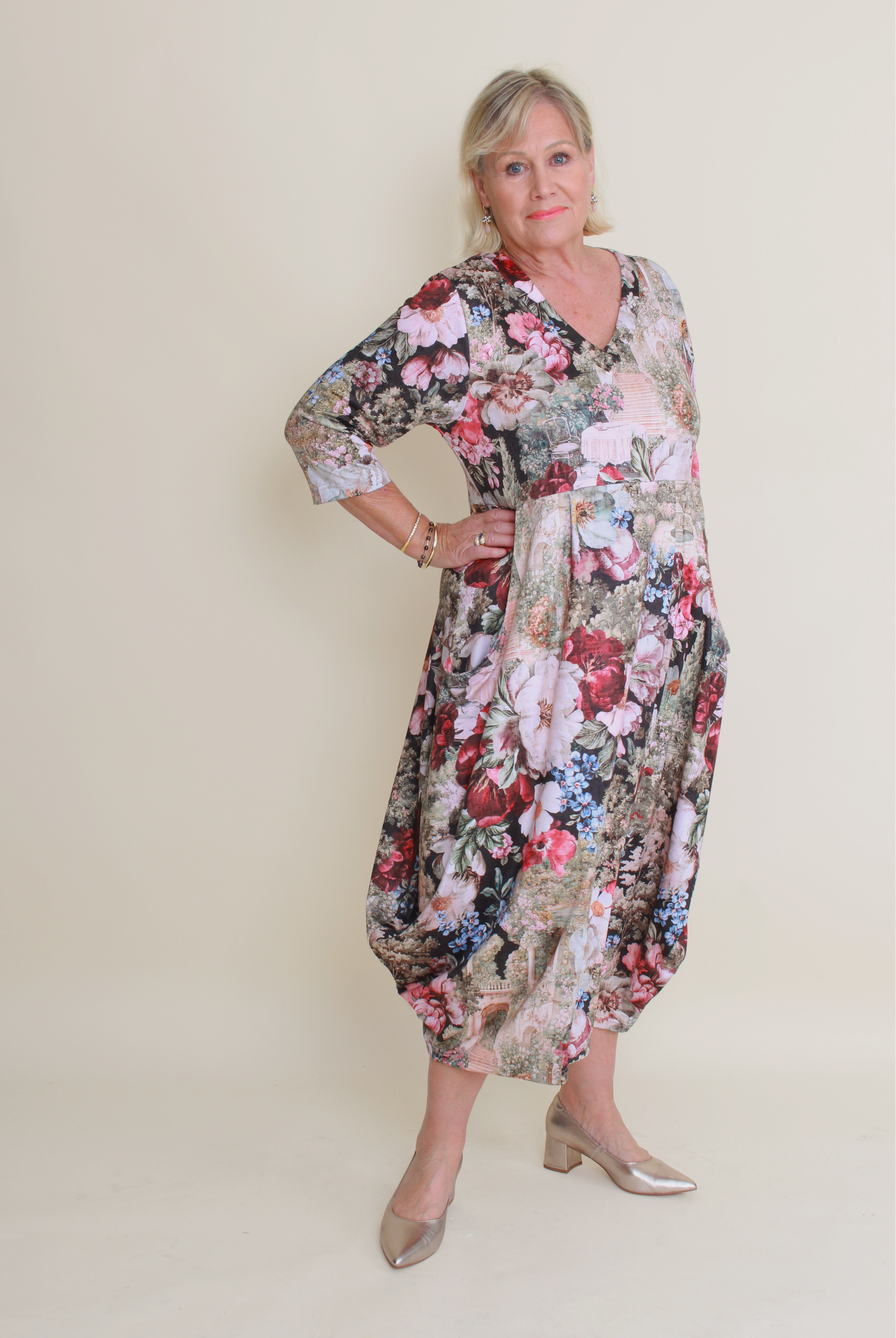 women wearing floral dress on a cream background