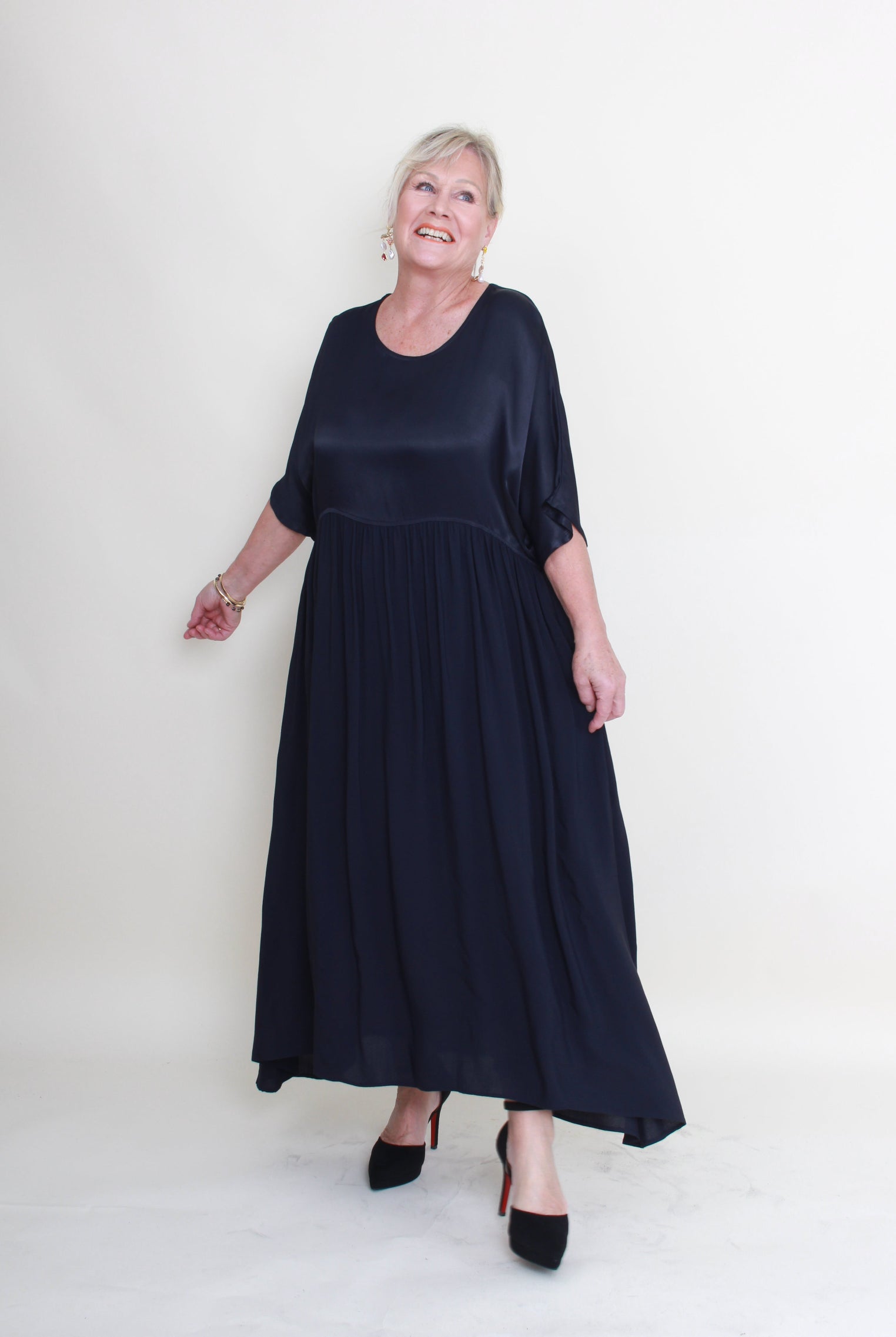 Woman wearing a navy blue dress on a white background