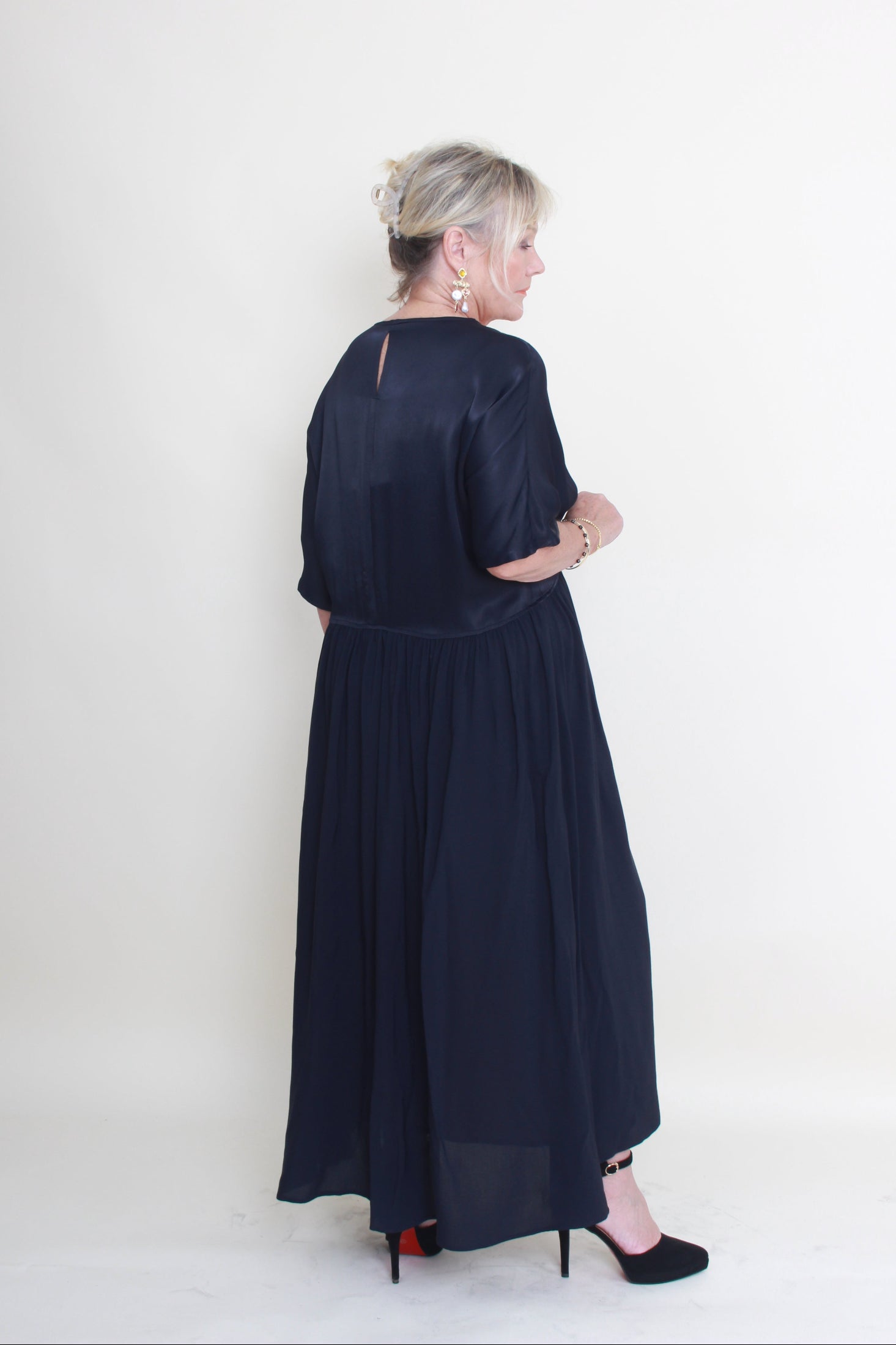 Woman wearing a dark blue dress on a white background