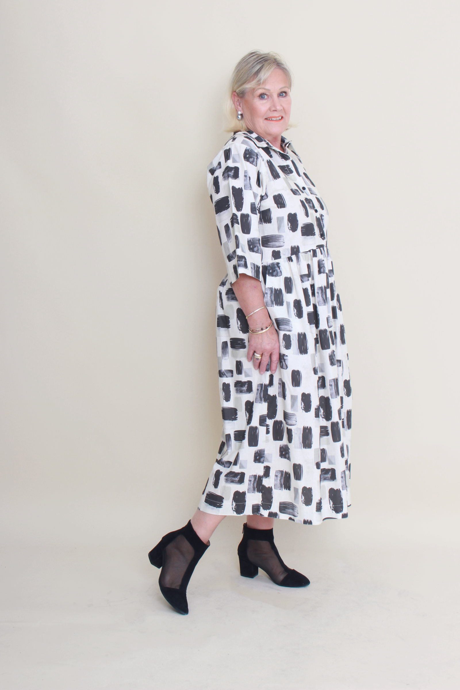 women wearing a patterned dress on a plain background
