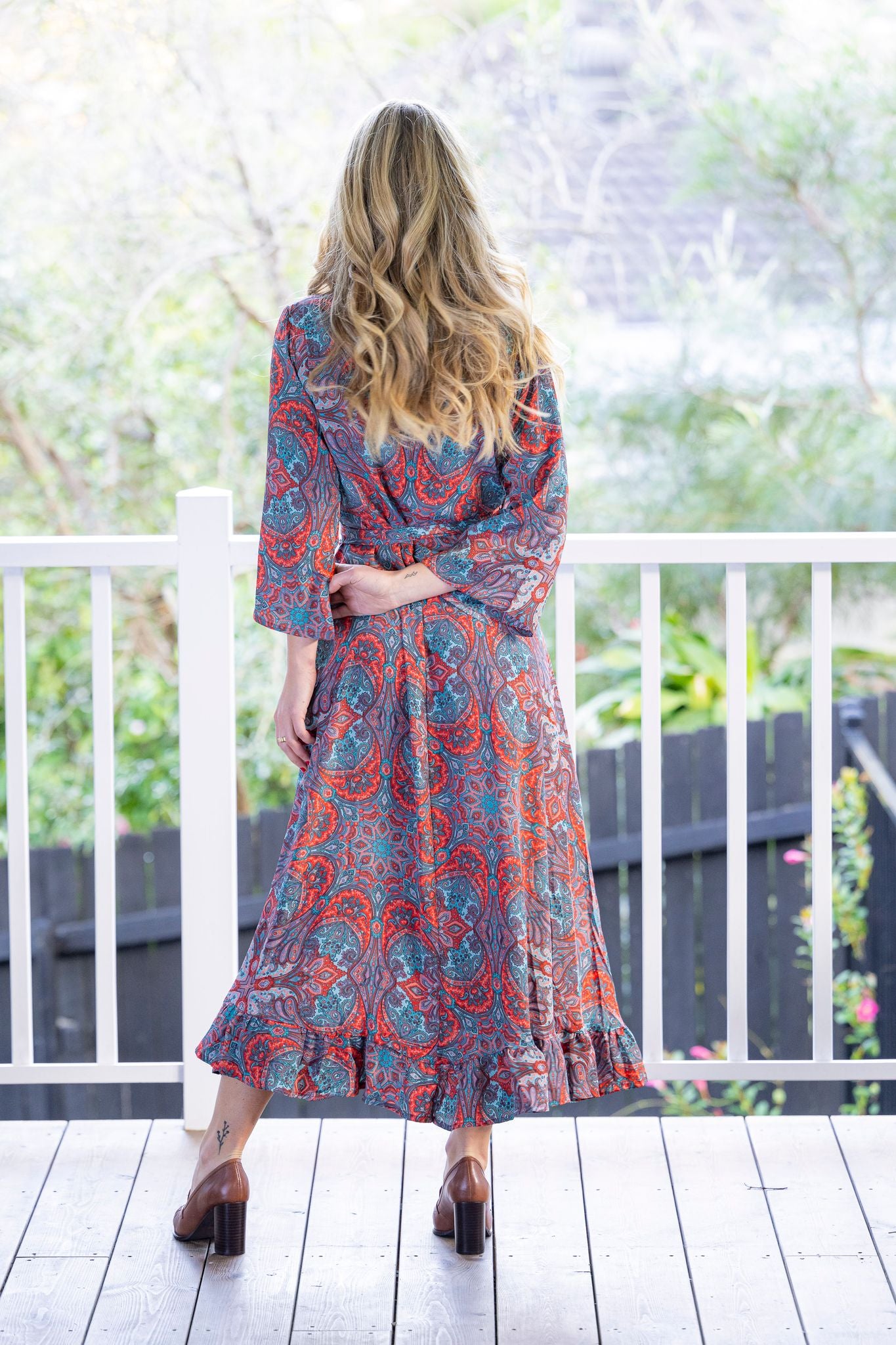 long wrap dress red blue paisley print worn by model back view