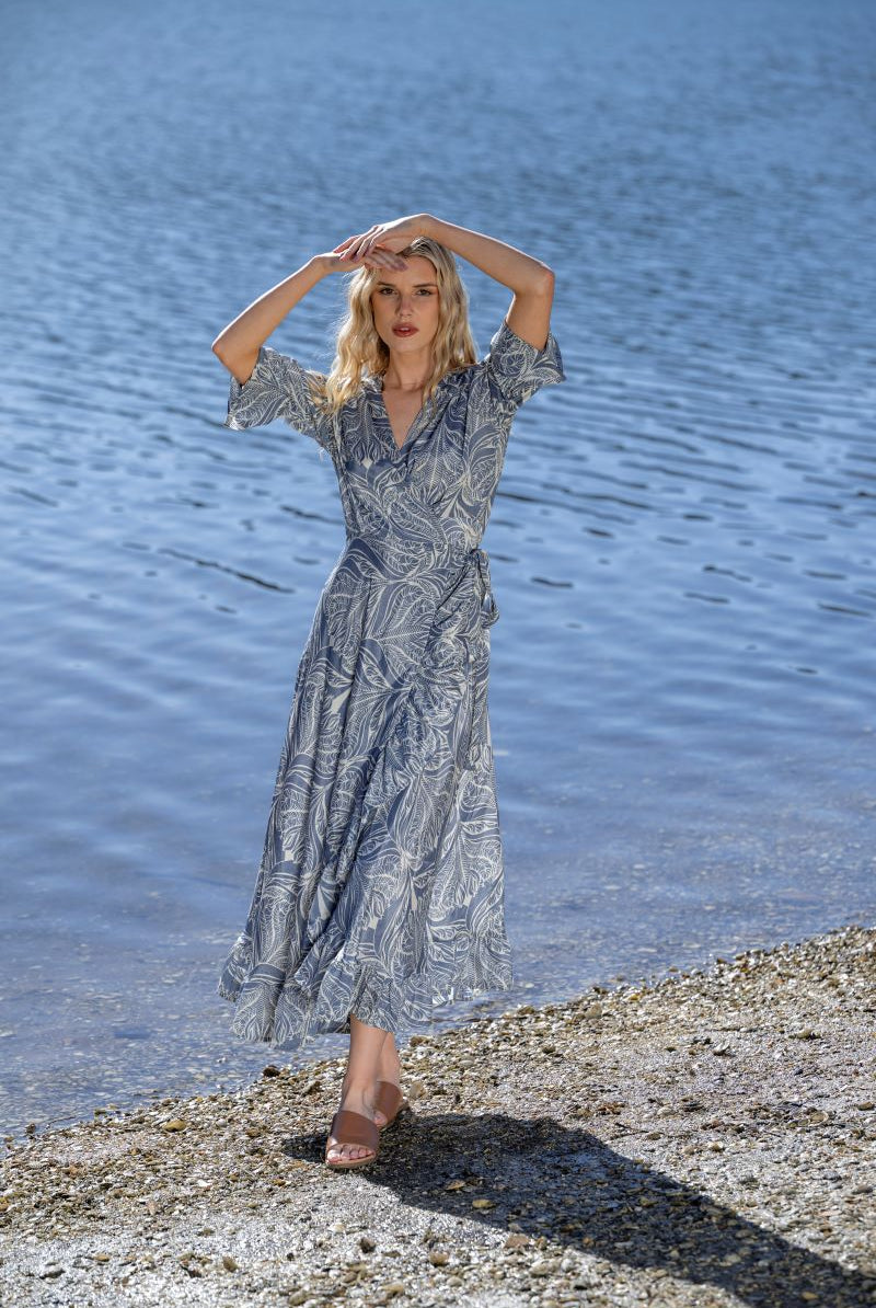 midi wrap dress blue cream print worn by model with lake background