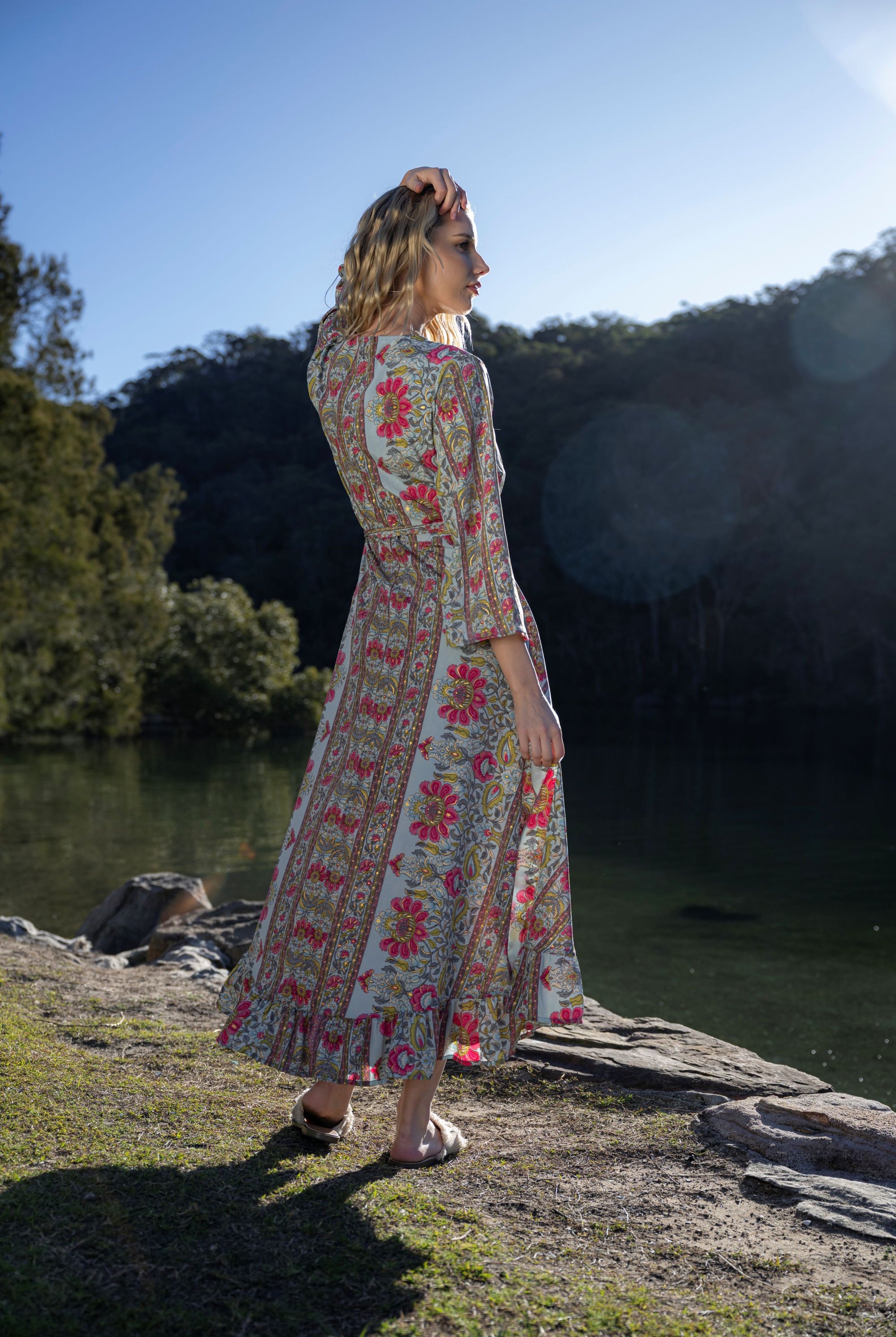 long sleeve boho print maxi wrap dress worn by model outdoors back view