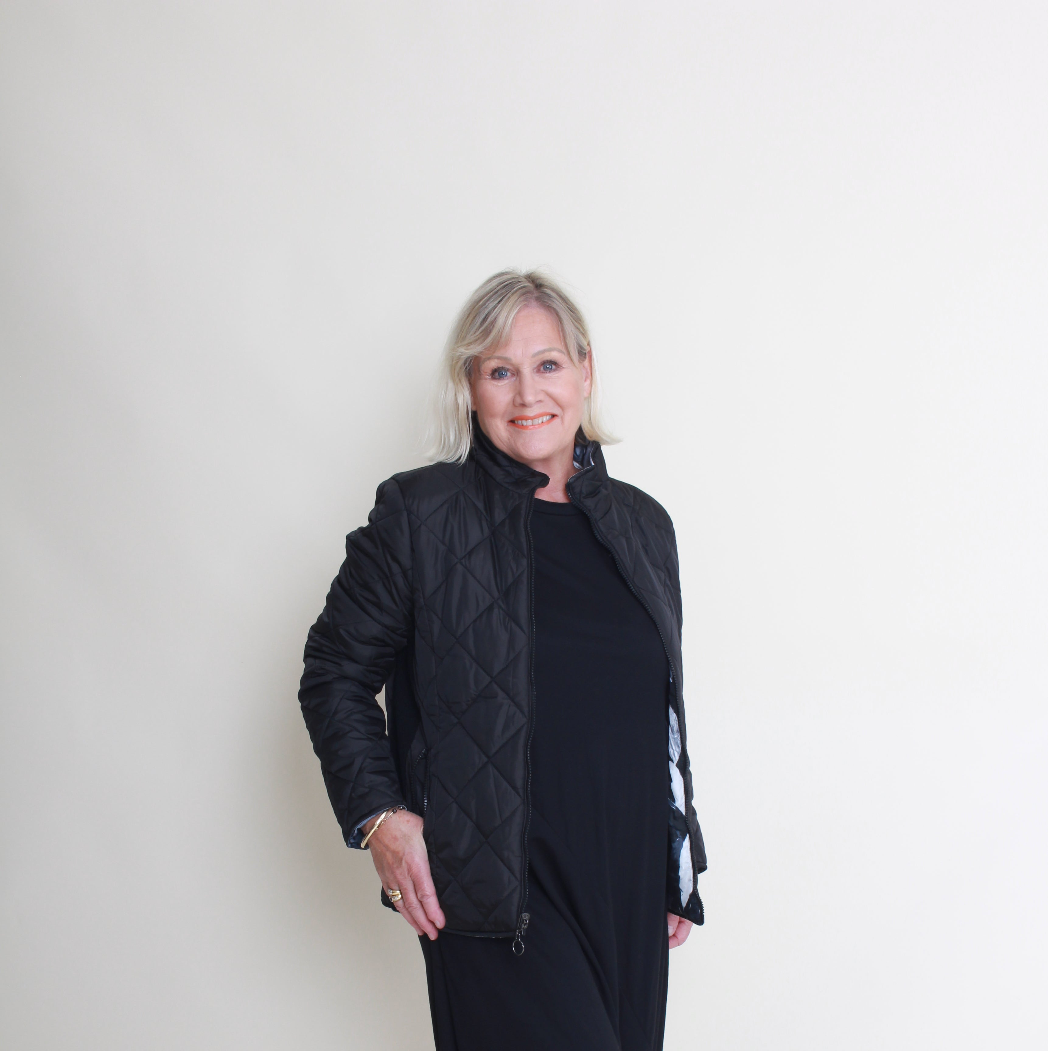 Person wearing a black coat on a white background