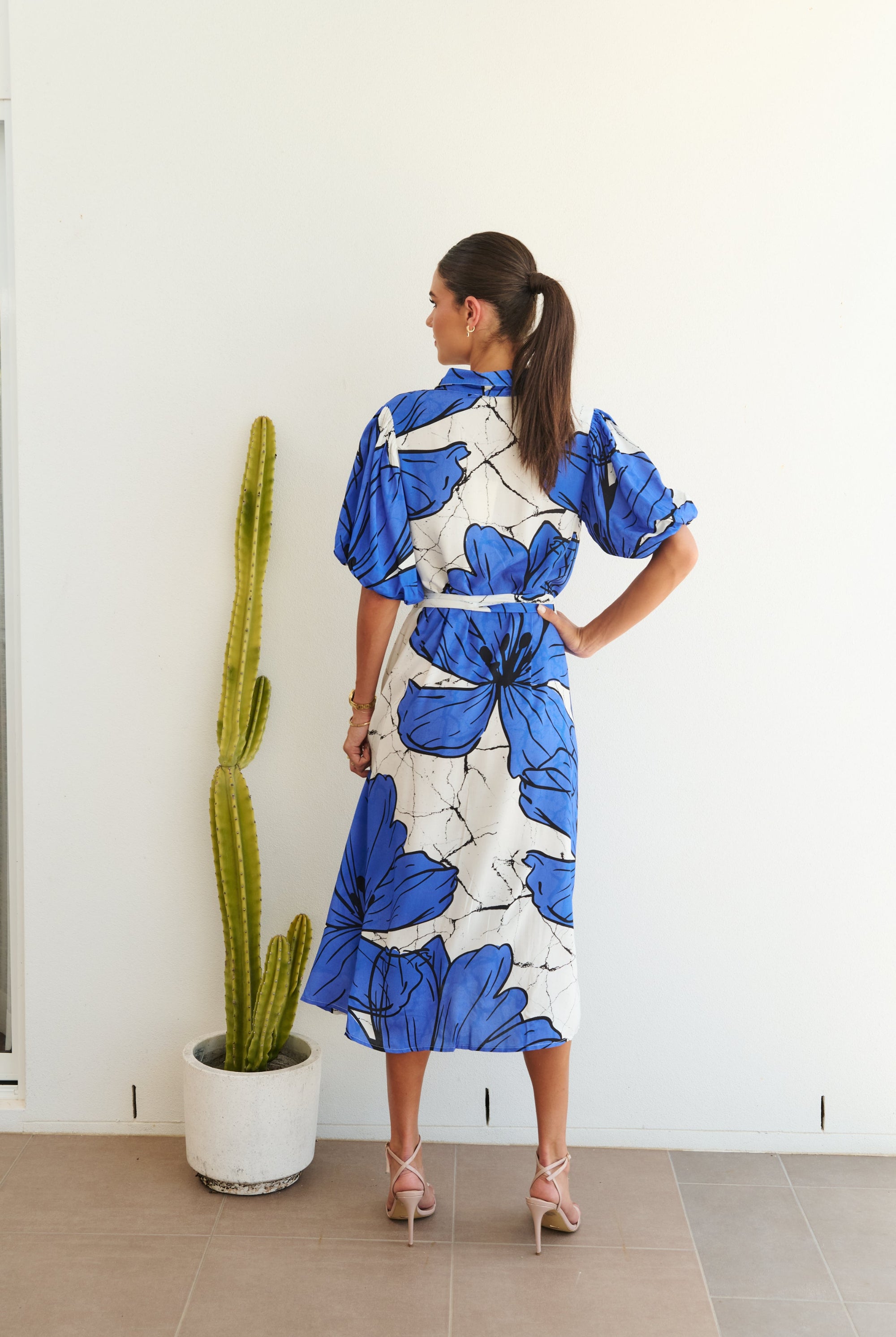 white blue large floral midi dress worn by model back view