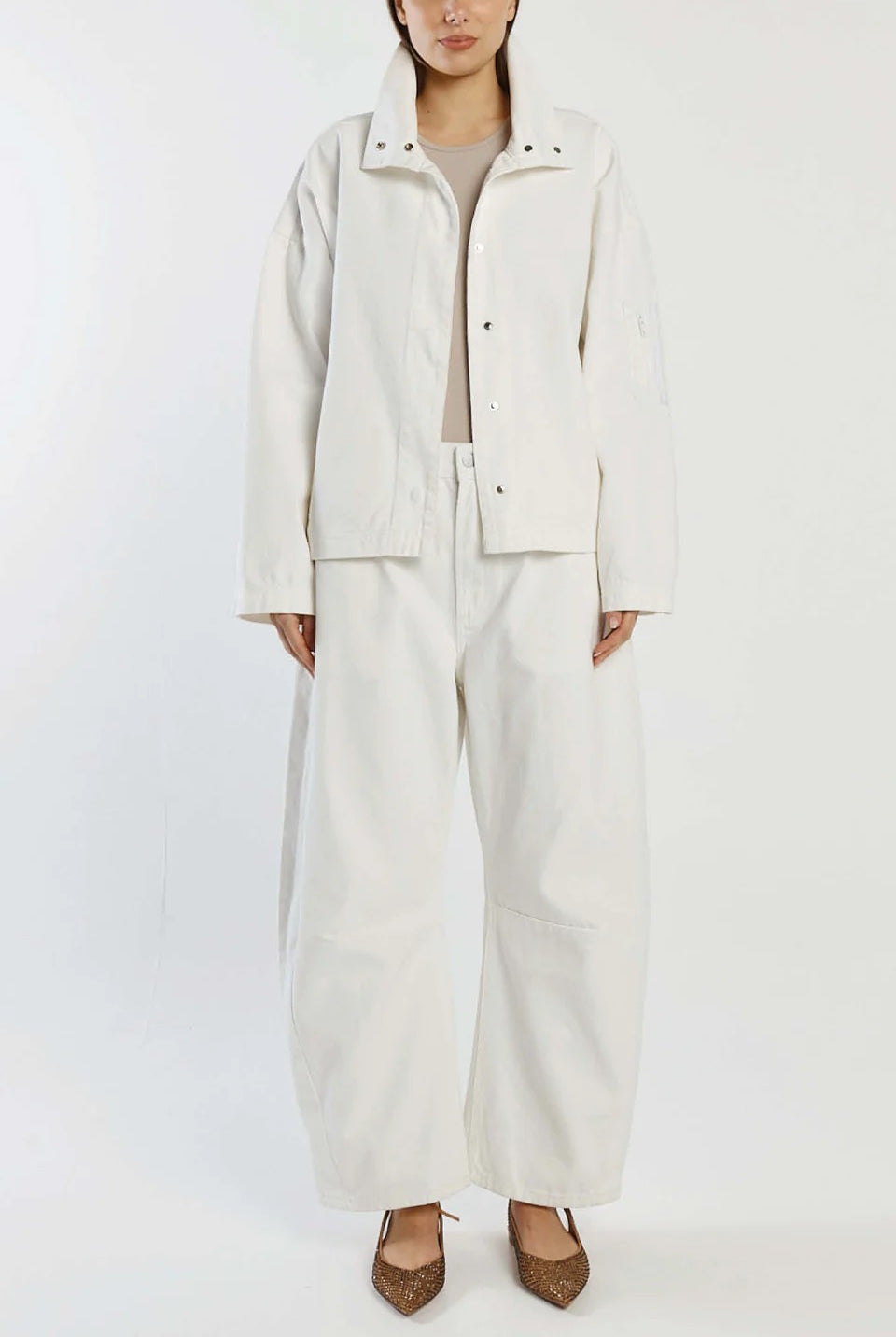 Person wearing a white outfit with a jacket and pants on a white background