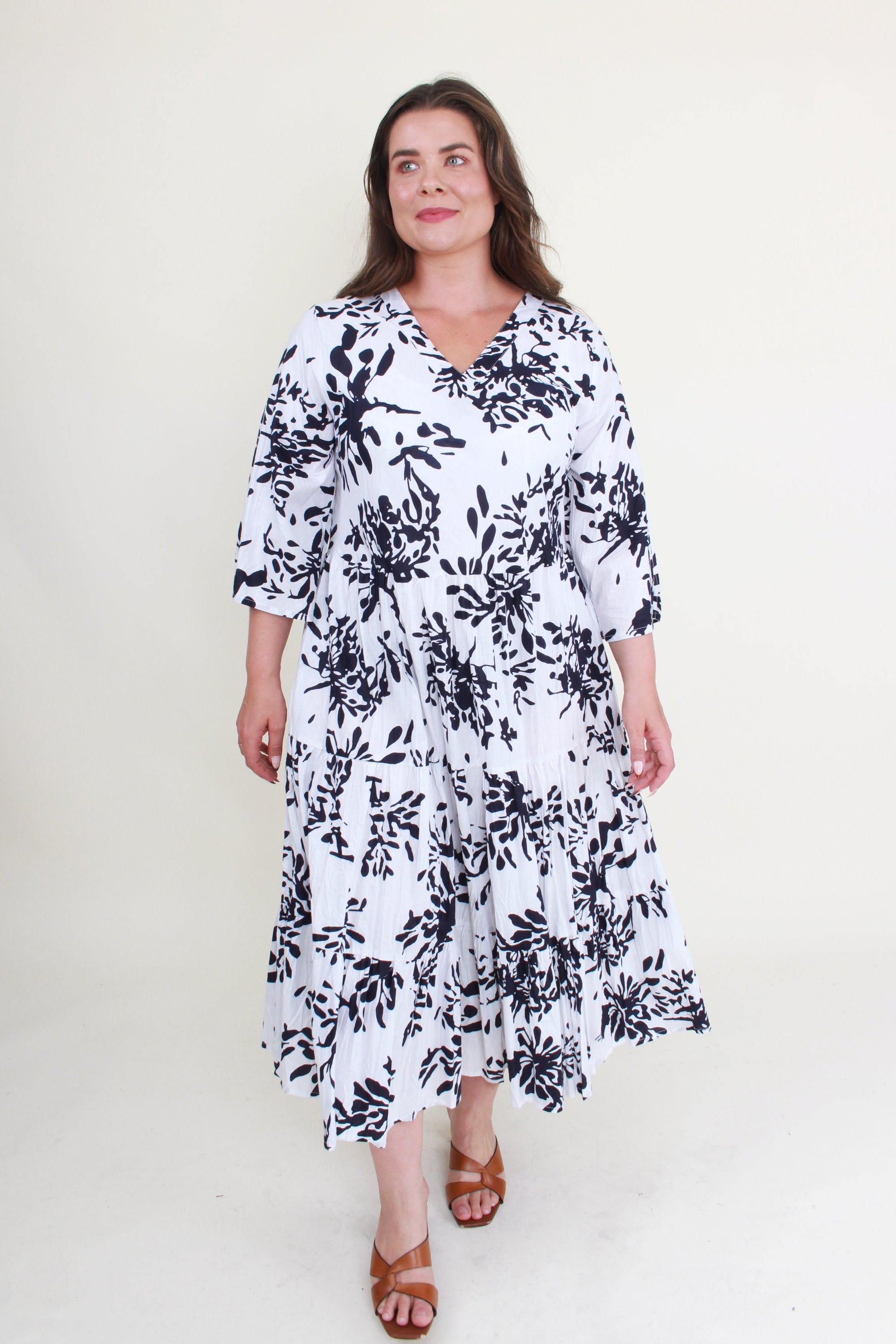 Woman wearing a black and white floral dress on a white background
