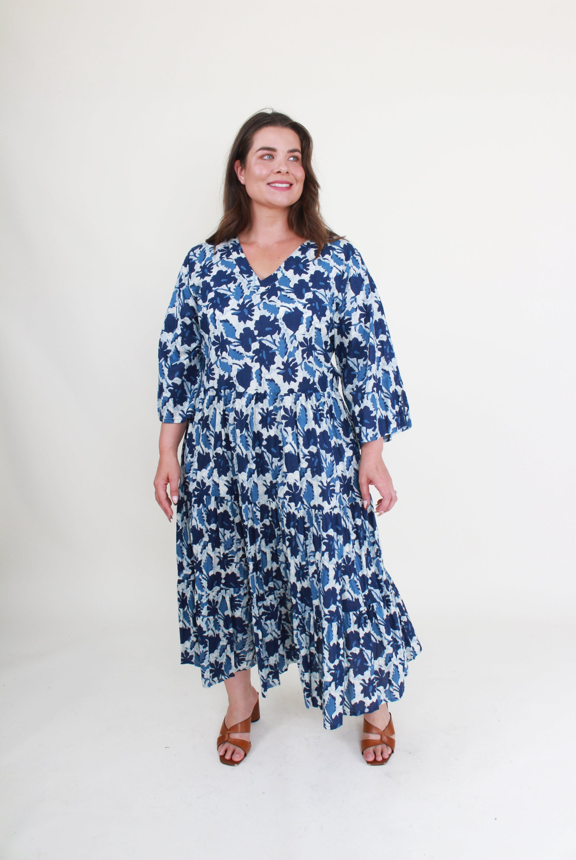 Woman wearing a blue floral dress on a white background