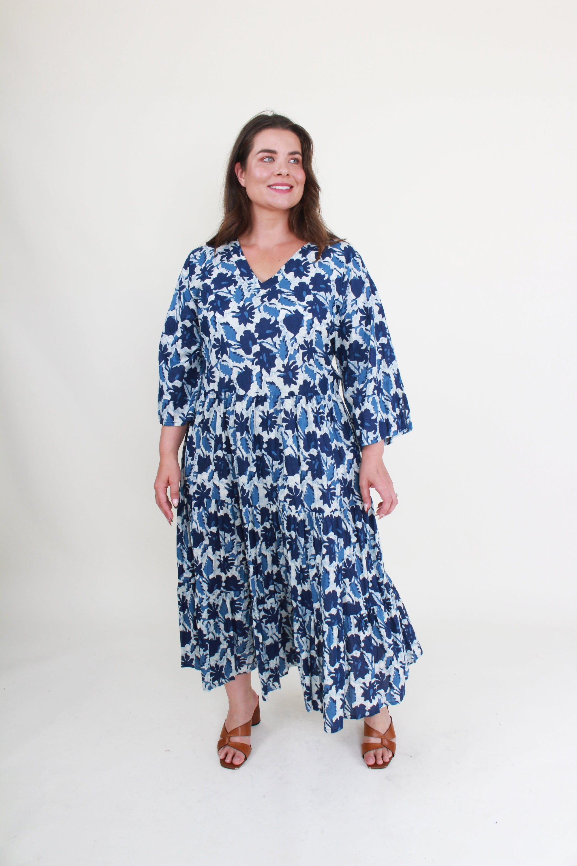 Woman wearing a blue floral dress on a white background