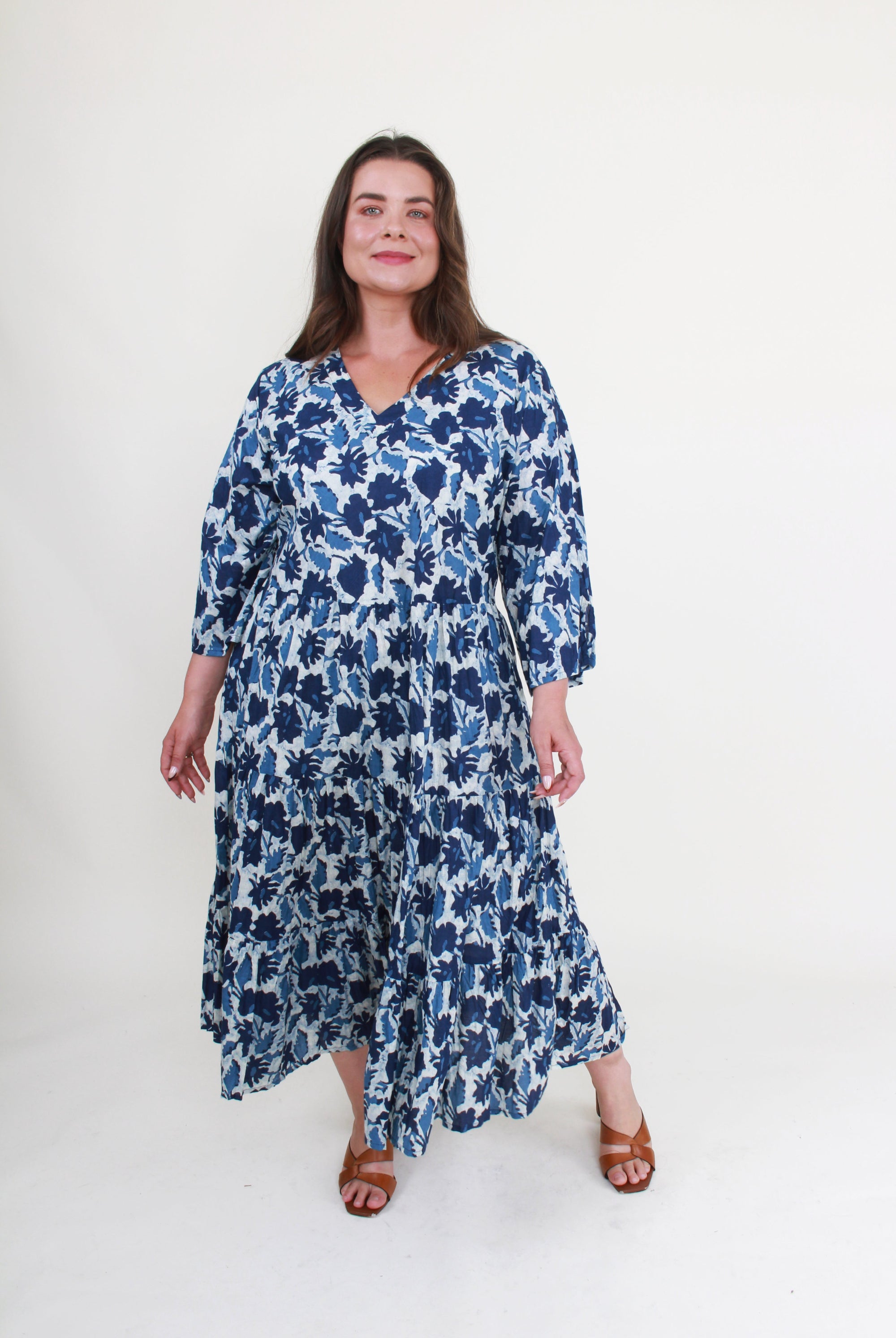 Woman wearing a blue floral dress on a white background