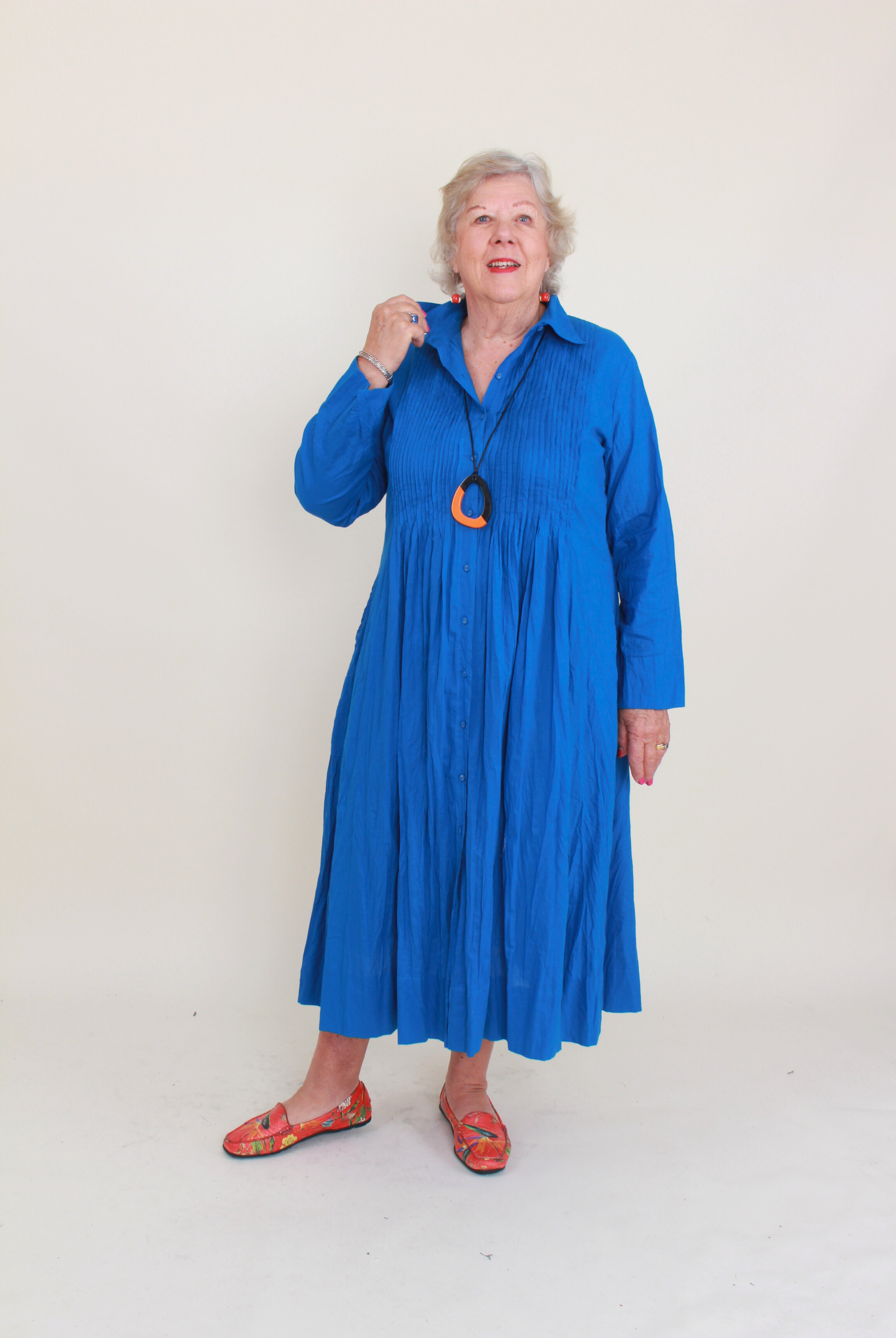 Woman wearing a blue dress with a white background