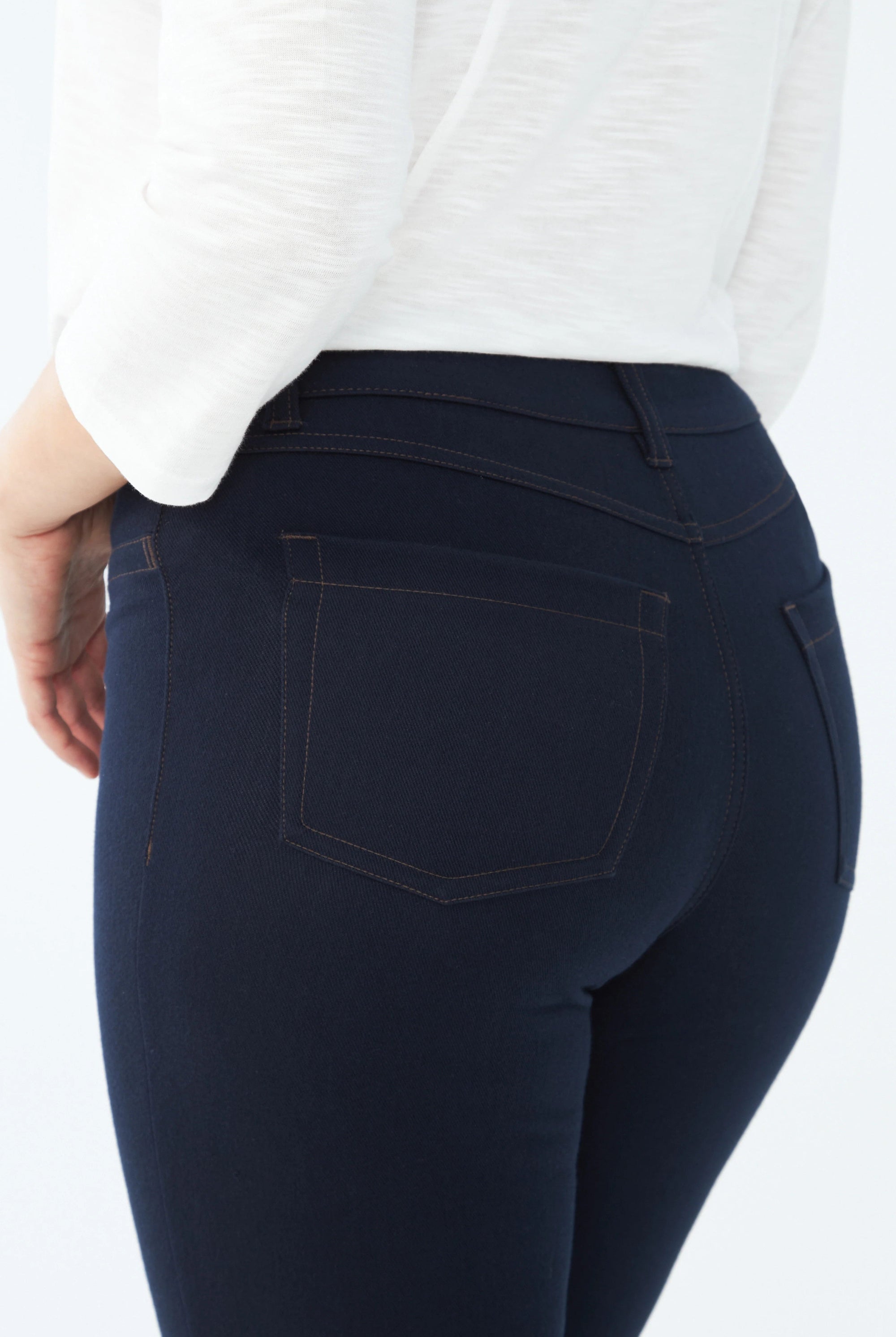 dark wash slim jean worn by model close up