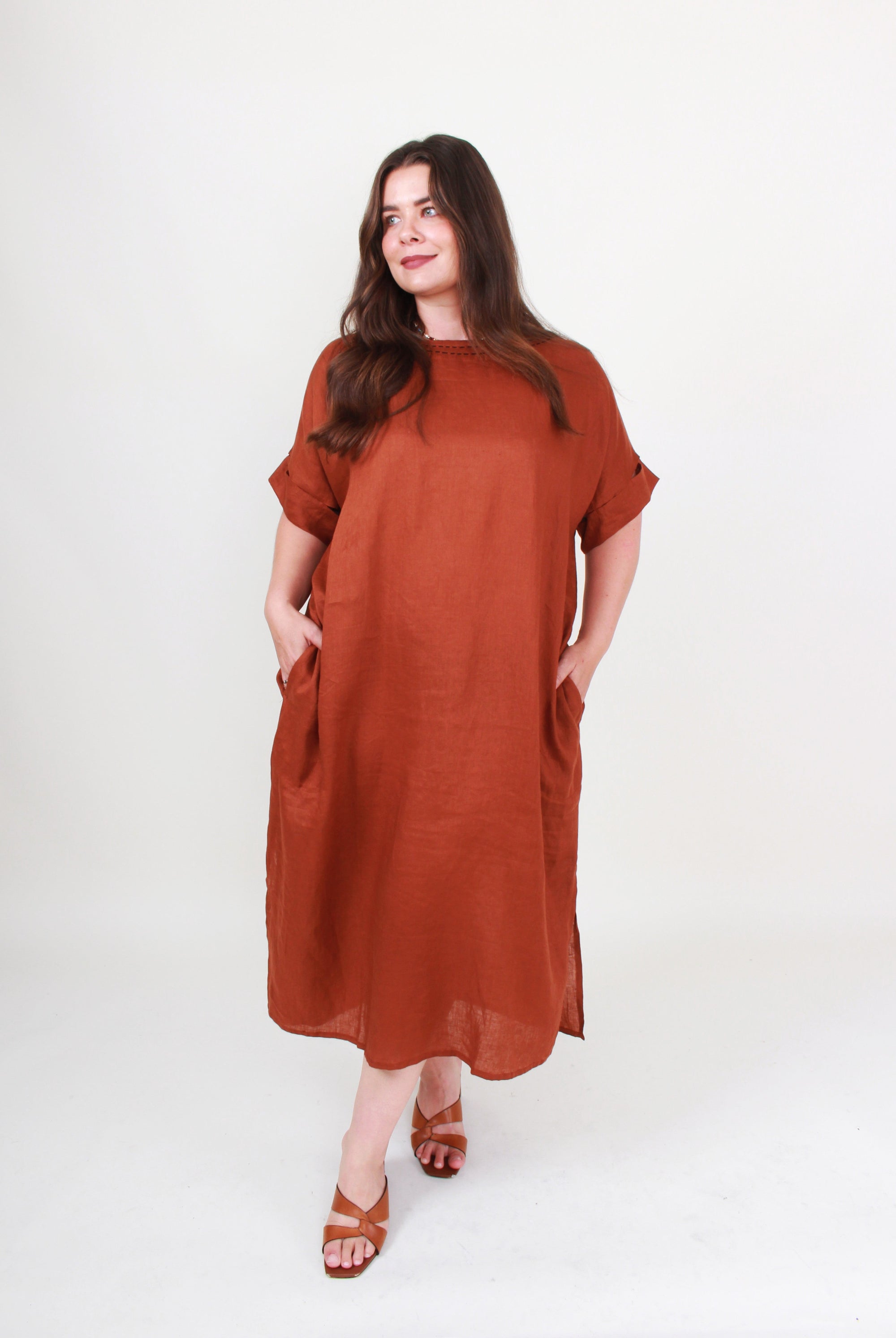 Woman wearing a brown dress on a white background