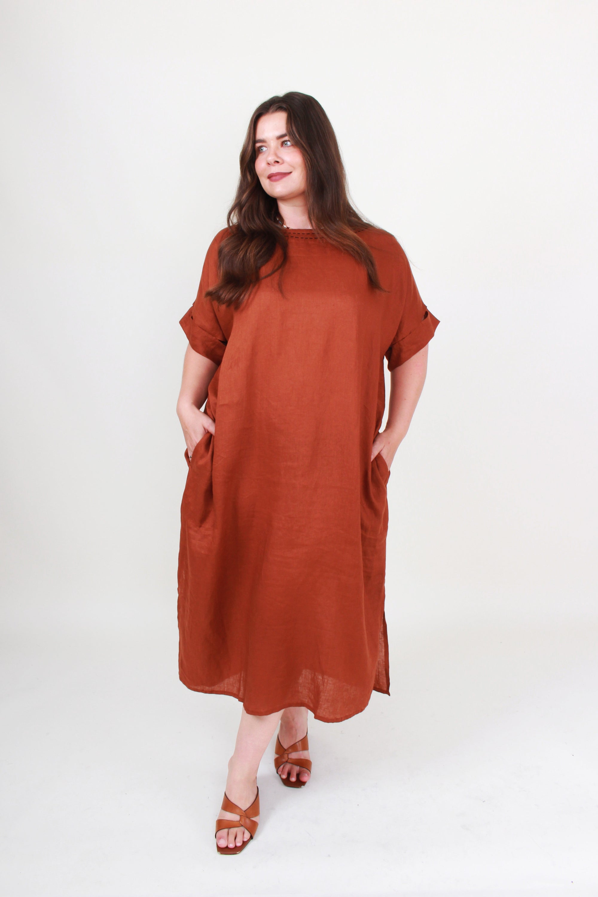 Woman wearing a brown dress on a white background