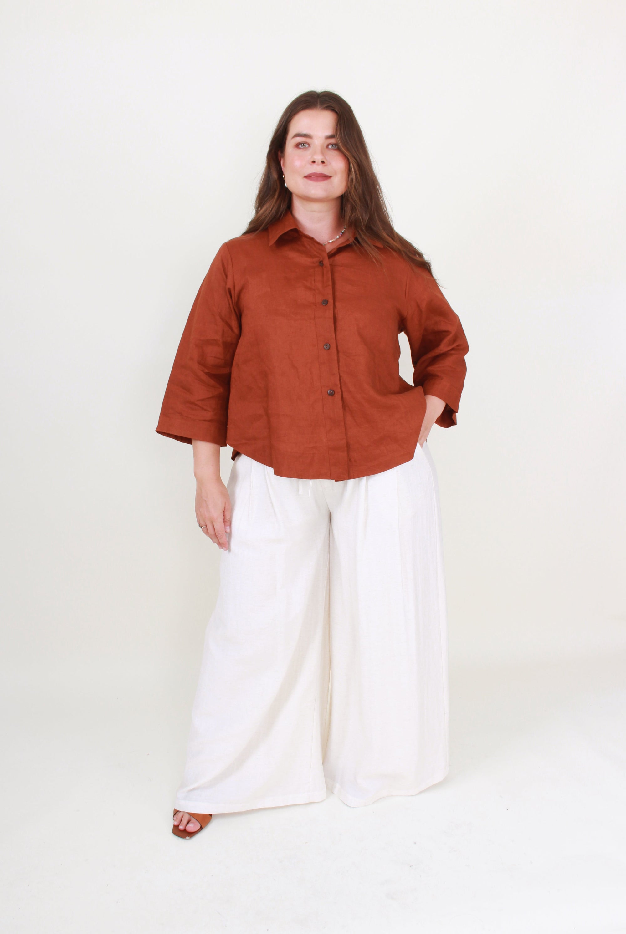 linen rust top and white pants worn by model