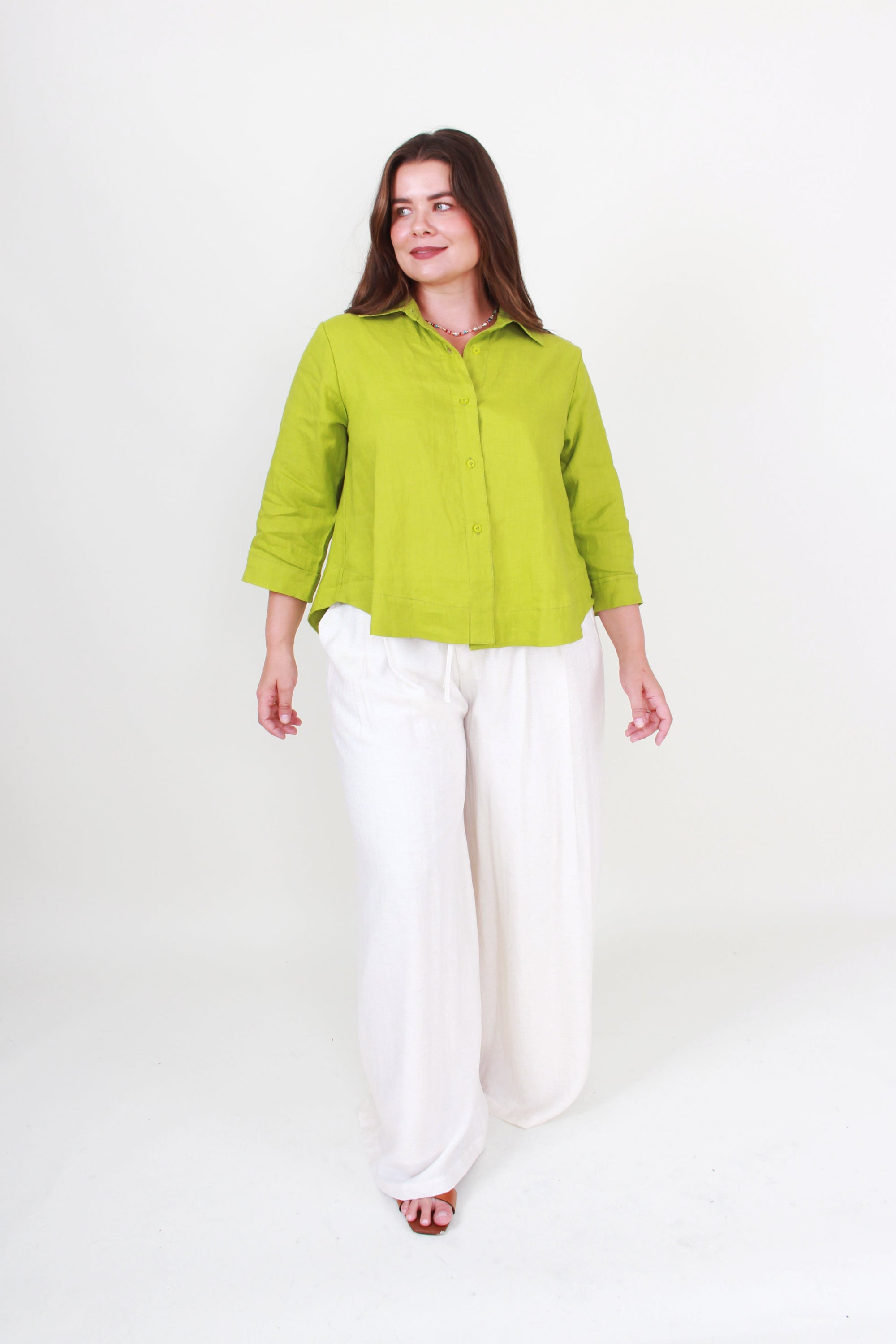 linengreen top and white pants worn by model