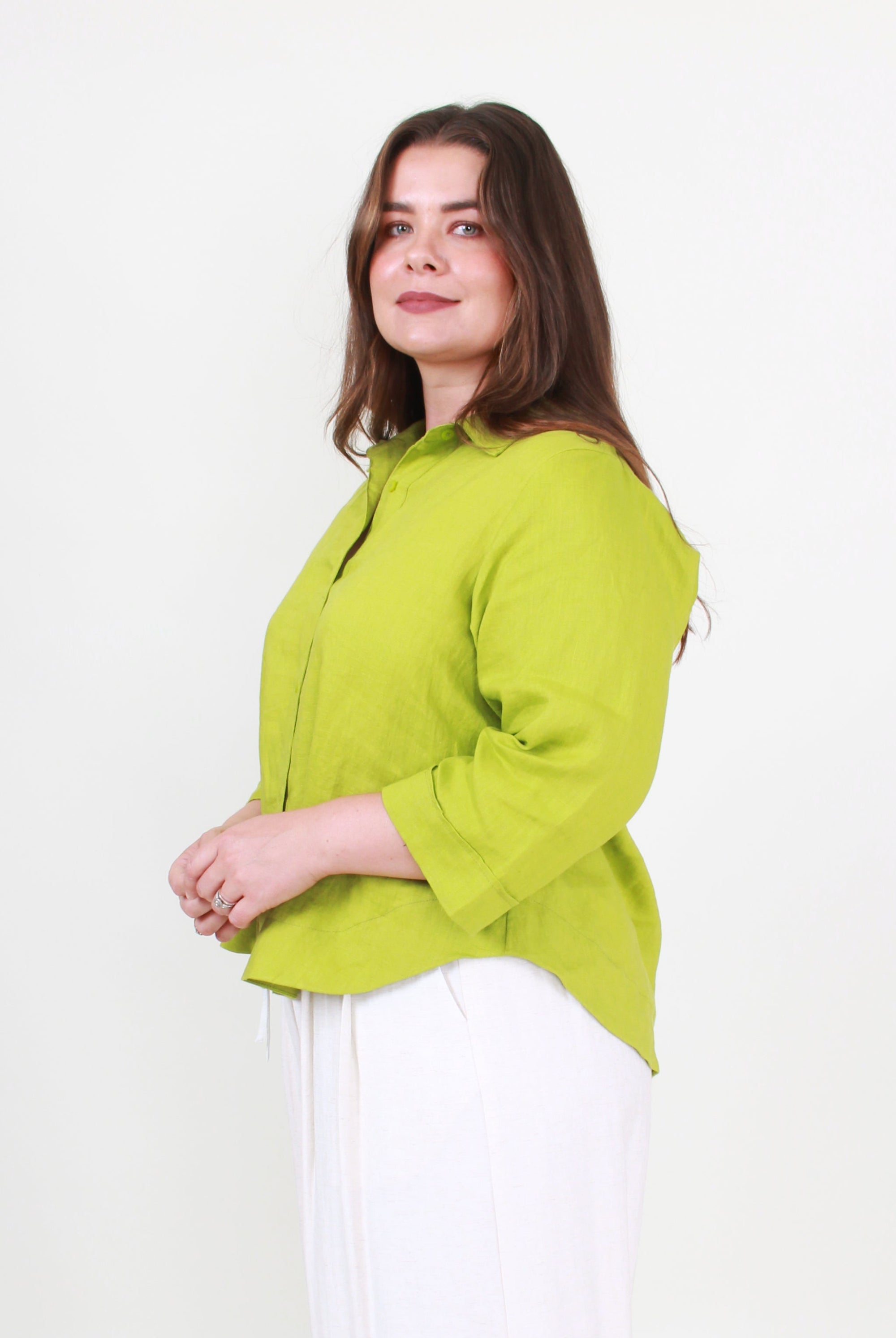 Woman wearing a green blouse against a white background