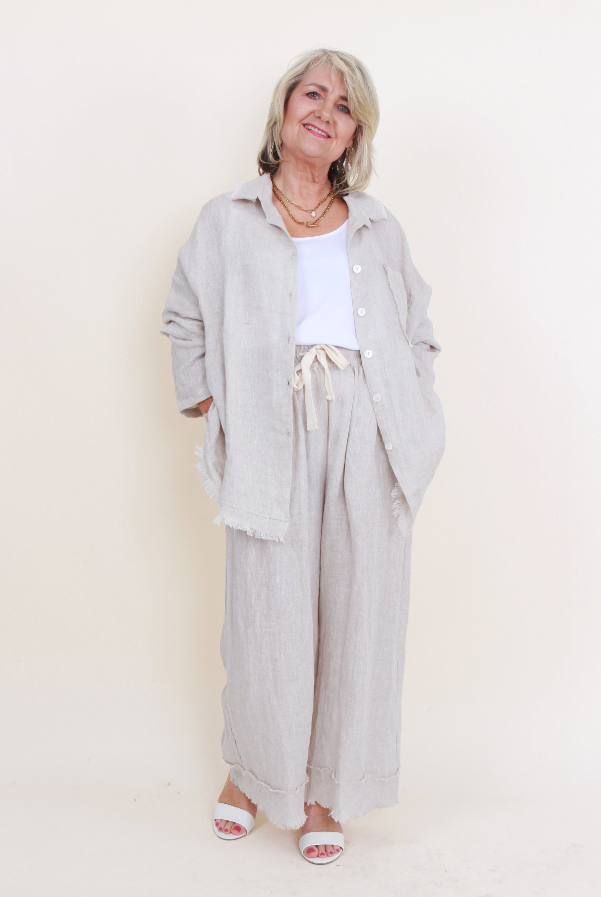 womens button through shirt worn open in sand worn by model