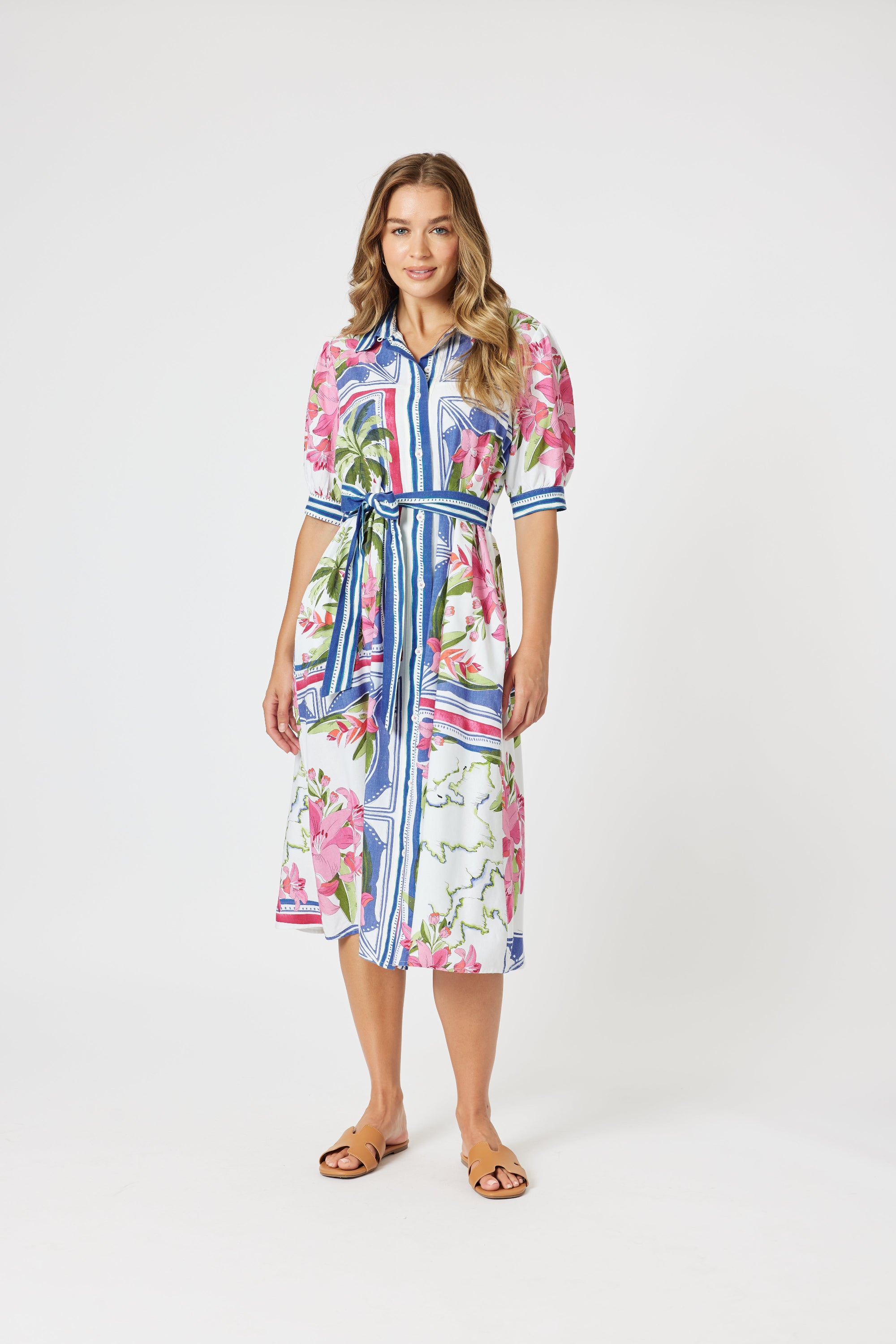 Woman wearing a colorful floral dress on a white background