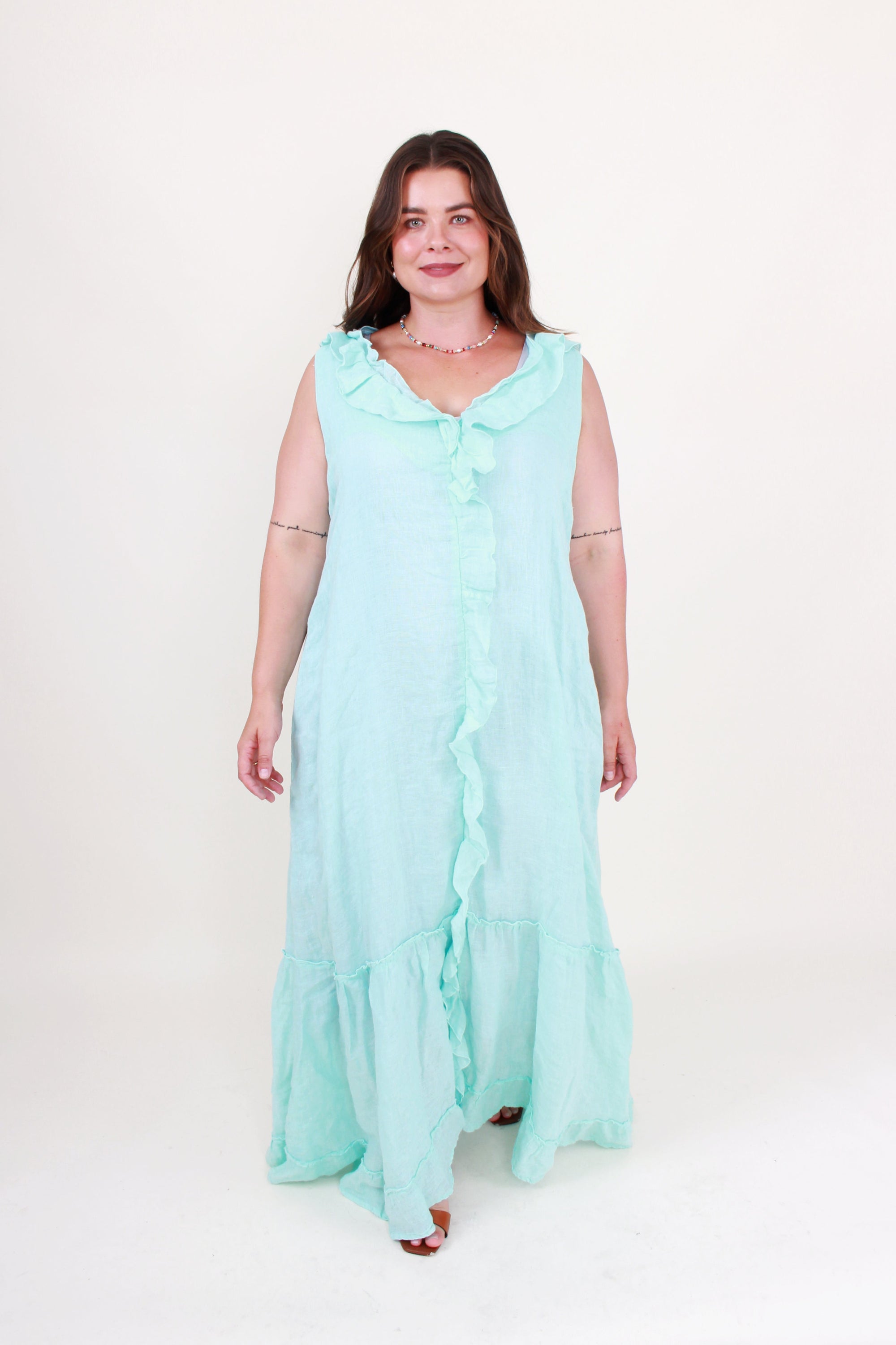 Woman wearing a light blue dress on a white background
