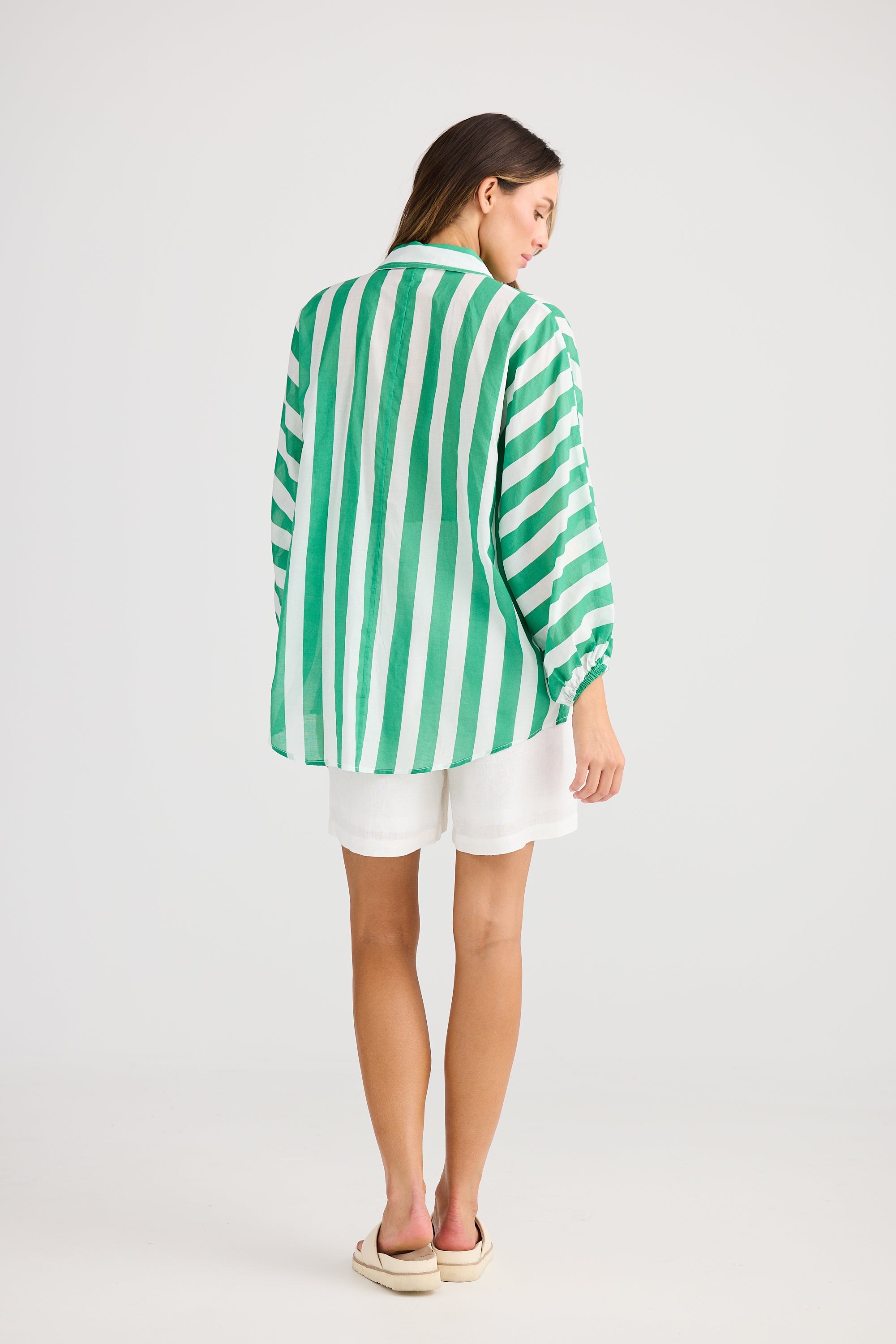 green and white vertical stripe shirt and white short worn by model back view