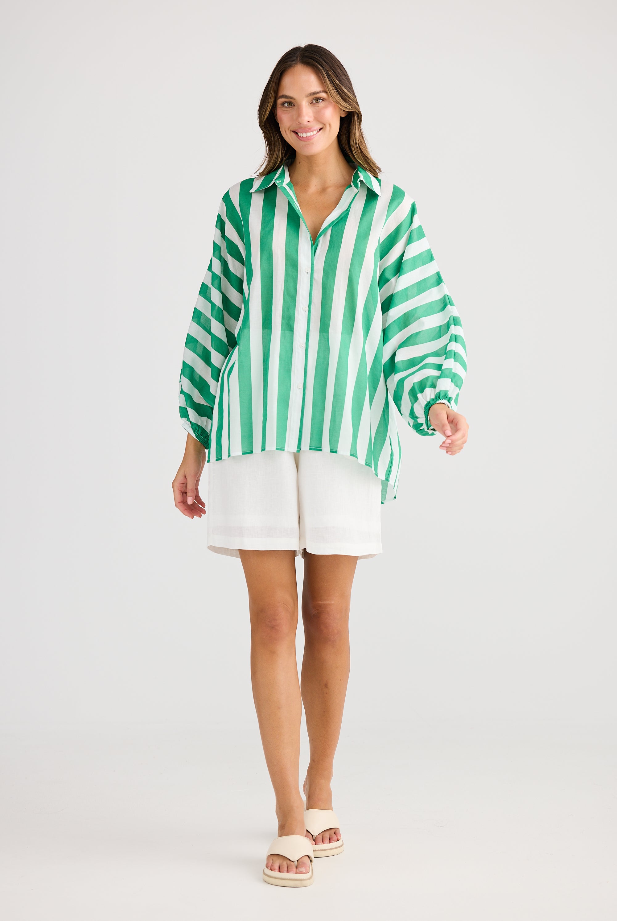 green and white vertical stripe shirt and white short worn by model