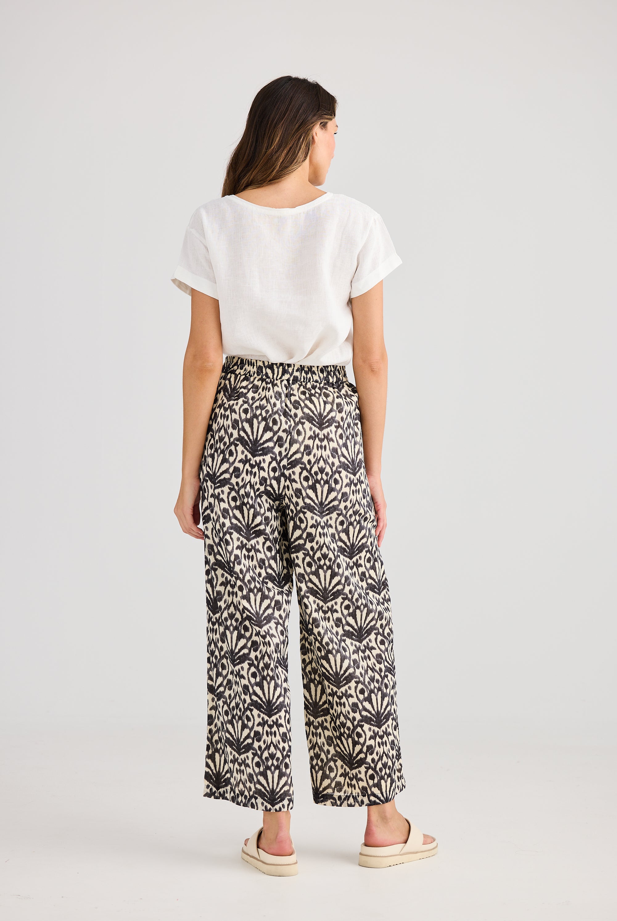 Wide leg pant cream and black fan print and white tee worn by model back view