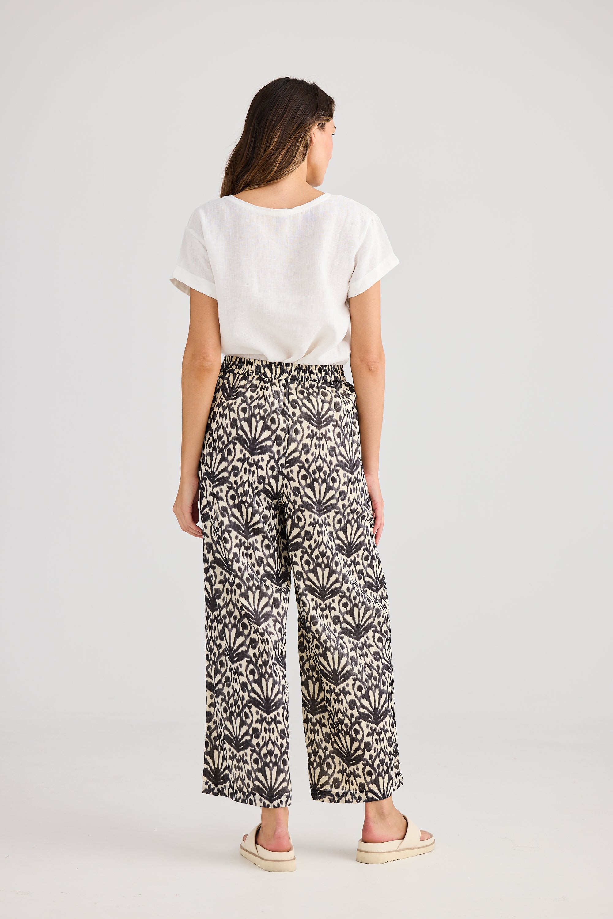 Wide leg pant cream and black fan print and white tee worn by model back view