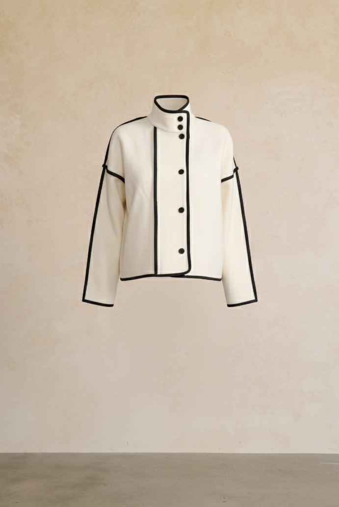 White jacket with black accents on a beige background