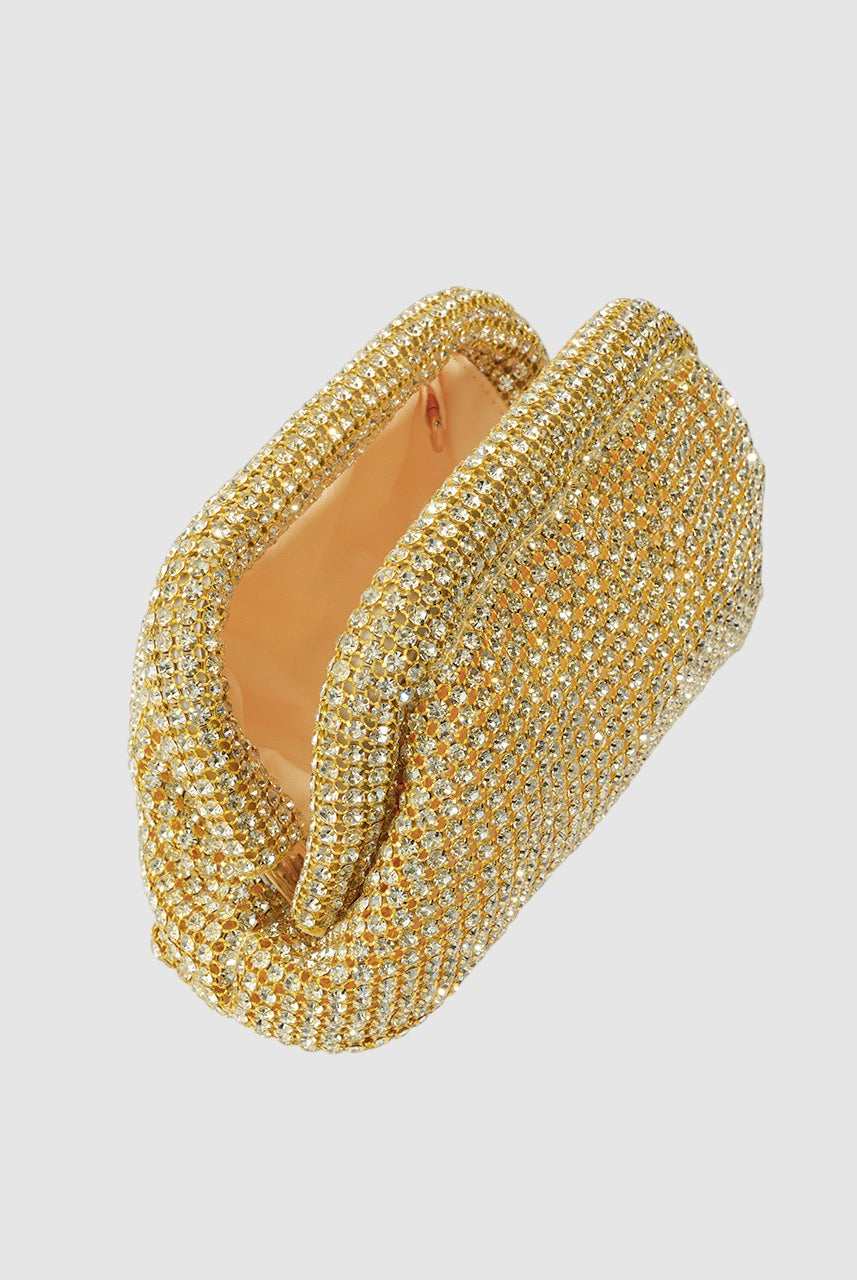 Gold bracelet with intricate design on a light gray background